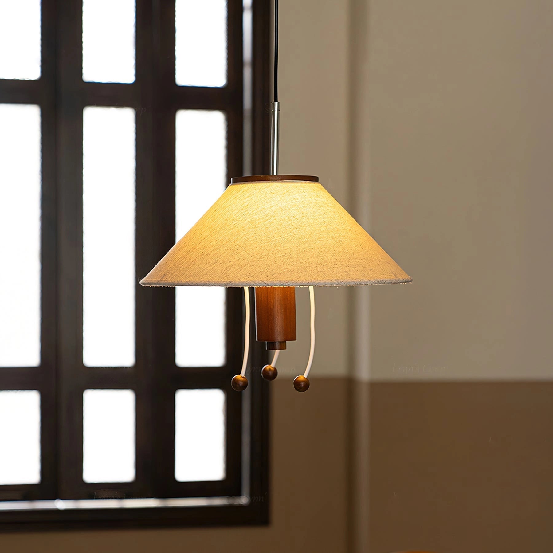 Modern triangle pendant lamp with wooden accents, adjustable lighting, featuring a geometric lampshade and sleek design, hanging in a room with natural light.