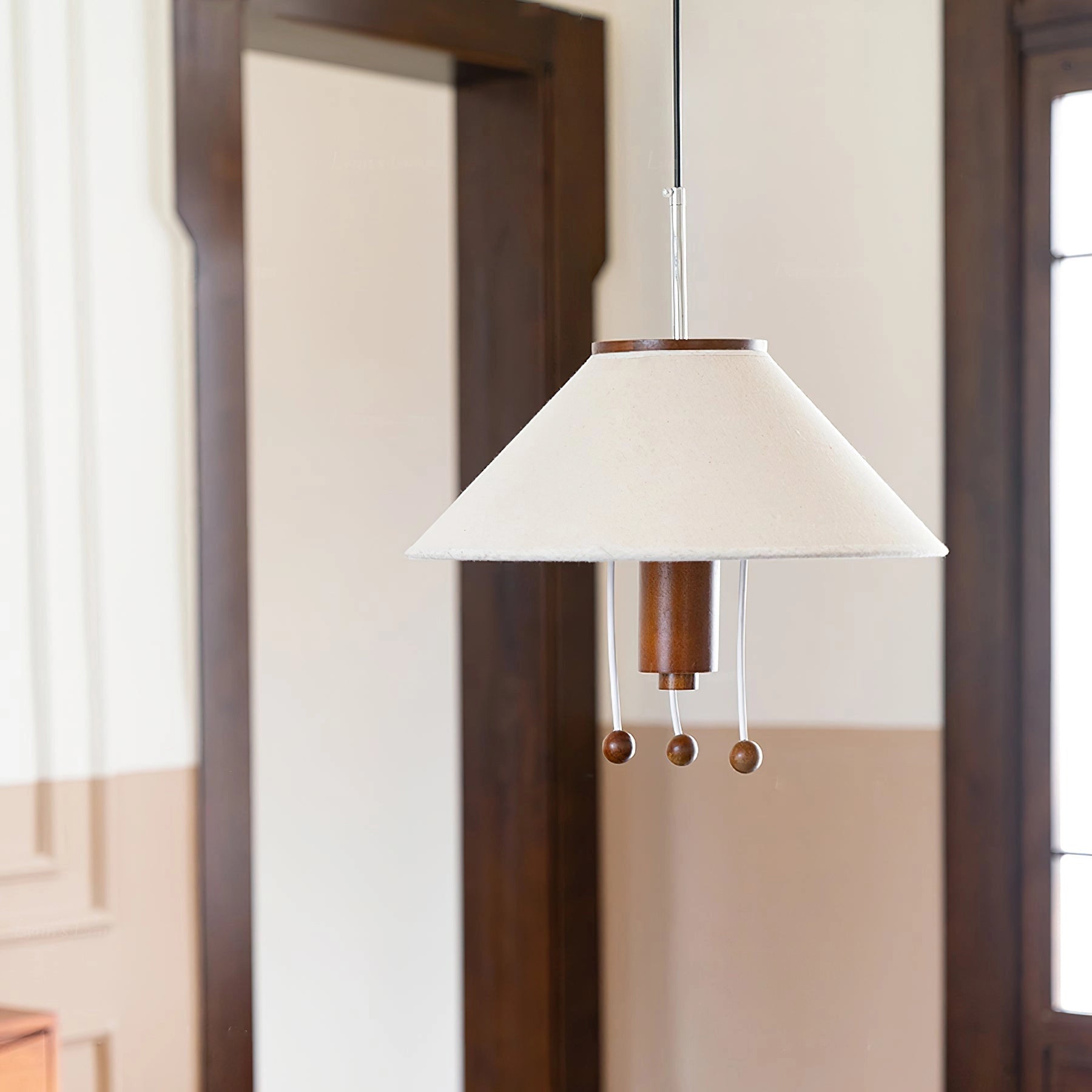 Modern triangle pendant lamp with wooden accents hanging from ceiling, showcasing adjustable lighting features.