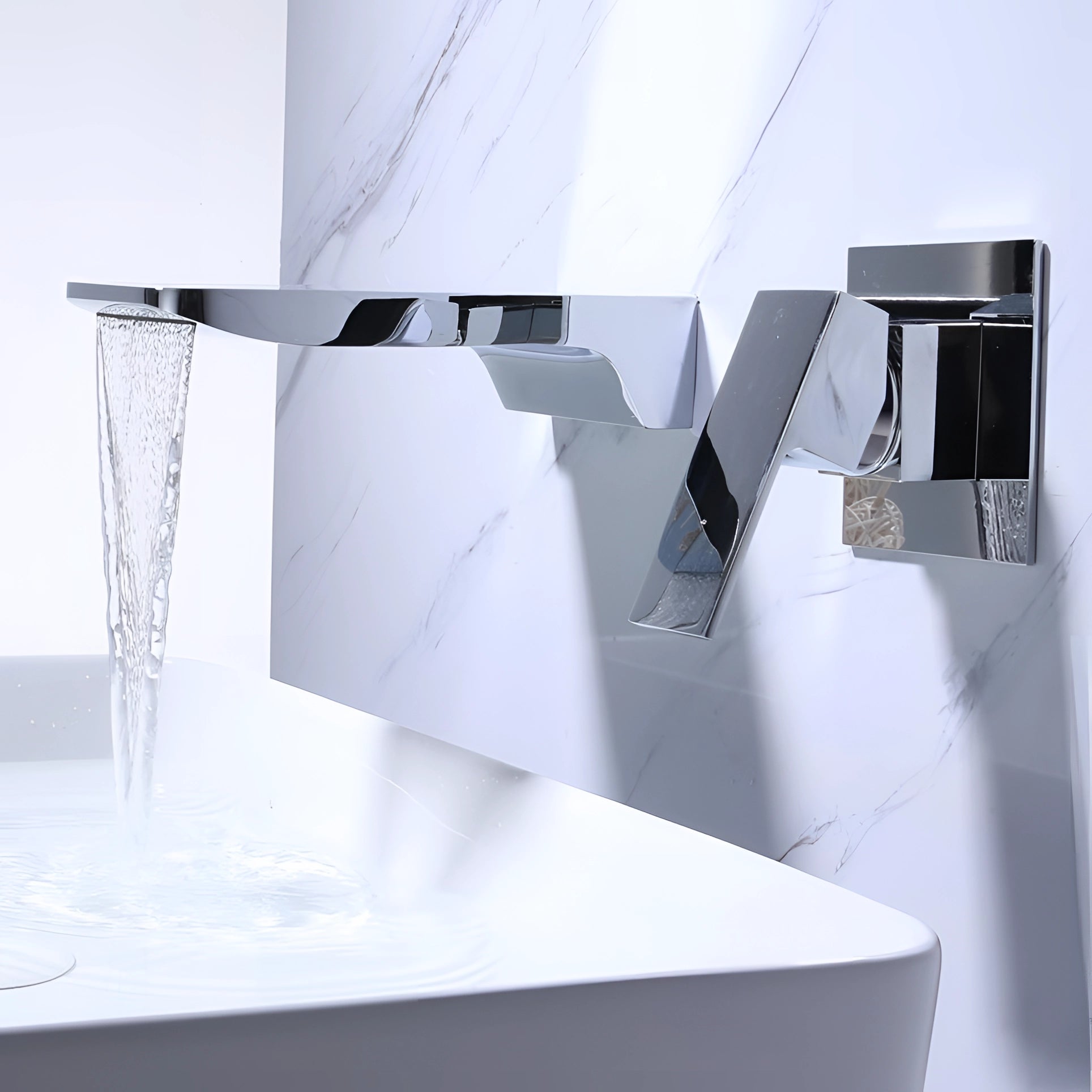 Sleek, modern wall-mounted waterfall faucet in chrome finish with a square design, elegantly installed against a neutral-toned wall surface, showcasing a contemporary architectural aesthetic.