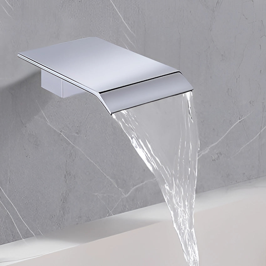 Chrome-finished, square design wall-mounted waterfall faucet installed on a modern bathroom wall.