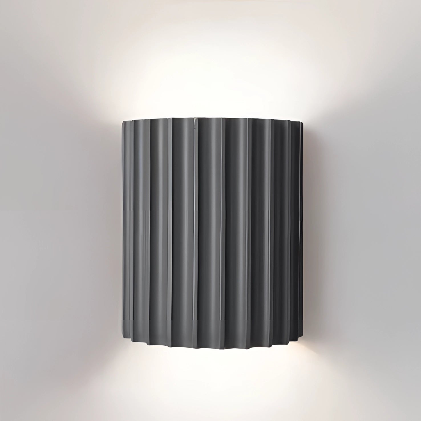 Modern white ribbed wall sconce with a rectangular and cylindrical design, featuring a gray finish, suitable for indoor use in USA/Canada with 110 V-120 V voltage. The contemporary lighting fixture is mounted on a wall, showcasing a sleek and minimalist aesthetic.