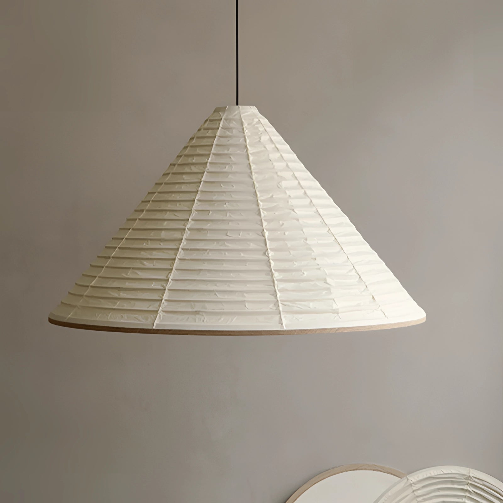 Modern white Scandinavian cone pendant light with a minimalist design, featuring a sleek triangular silhouette and symmetrical form hanging from the ceiling.