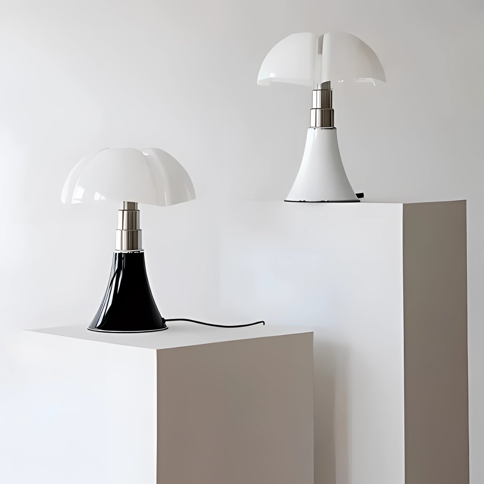 Modern white table lamp with a sleek, contemporary minimalist mushroom design, casting light in a stylish interior setting with grey and wood elements.