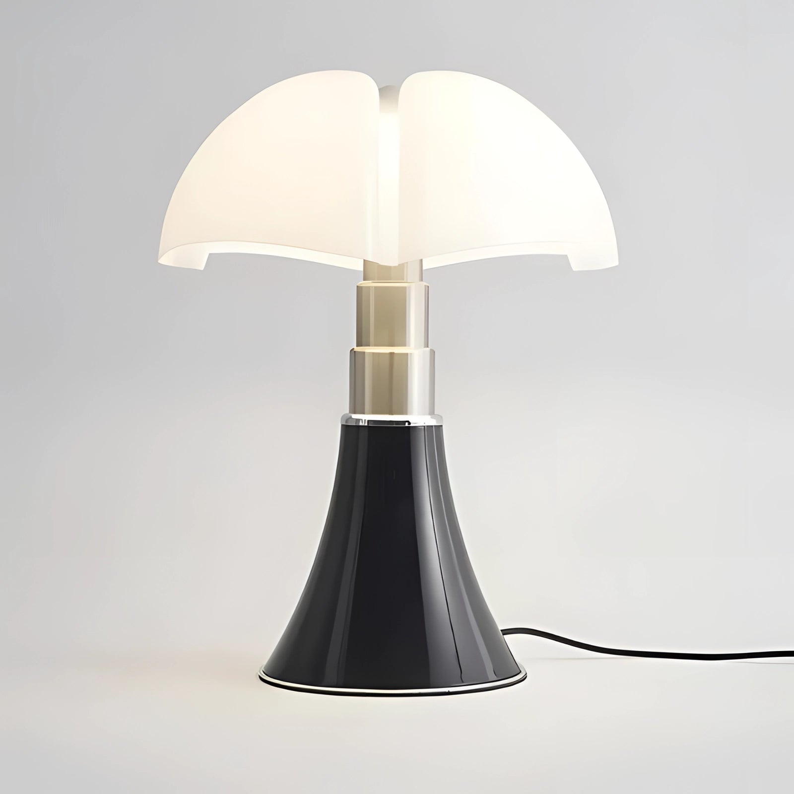 A sleek black table lamp in a contemporary minimalist mushroom design with a modern aesthetic.