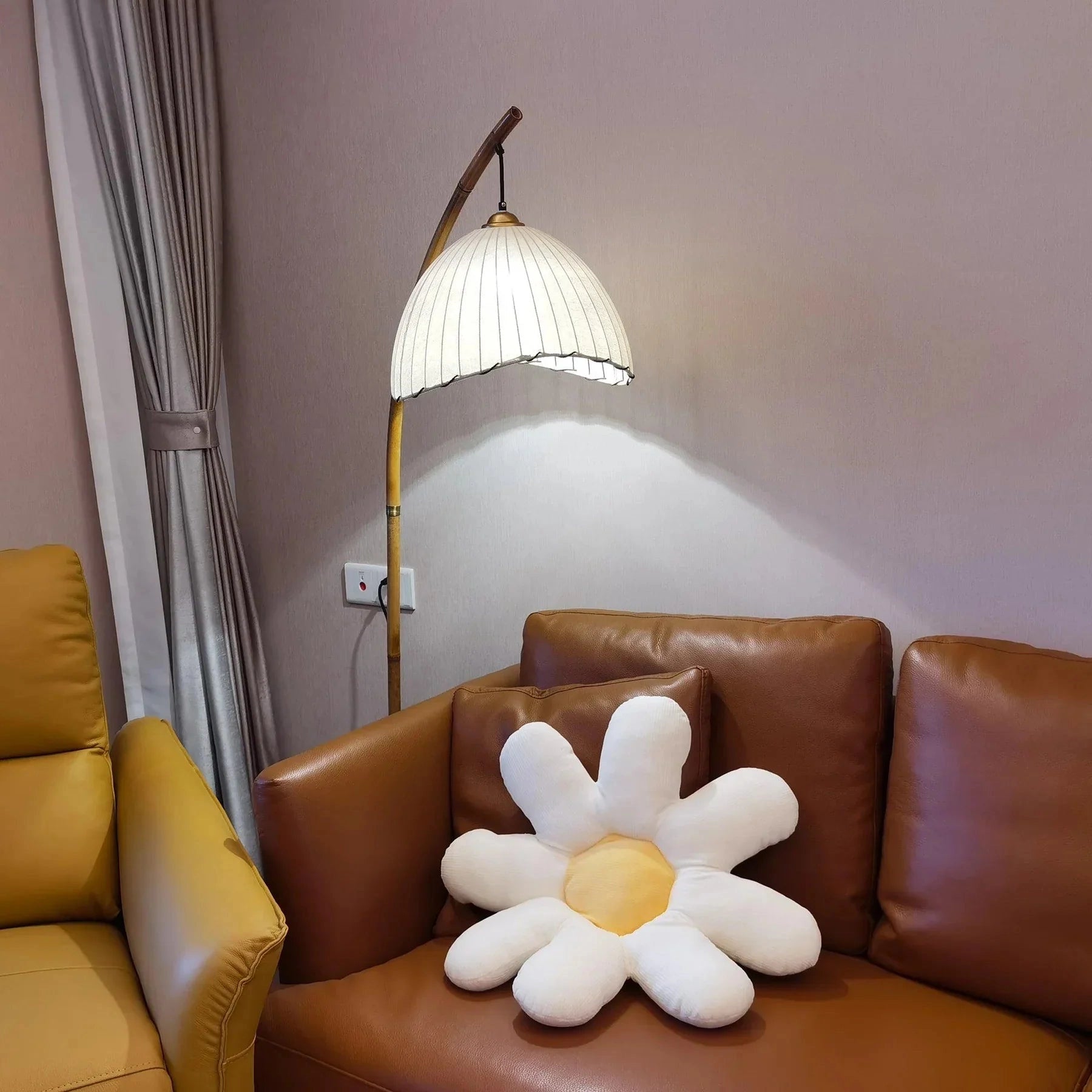 Plush daisy flower cushion with soft petals and vibrant colors displayed on a cozy home interior setup with wooden accents and ambient lighting.