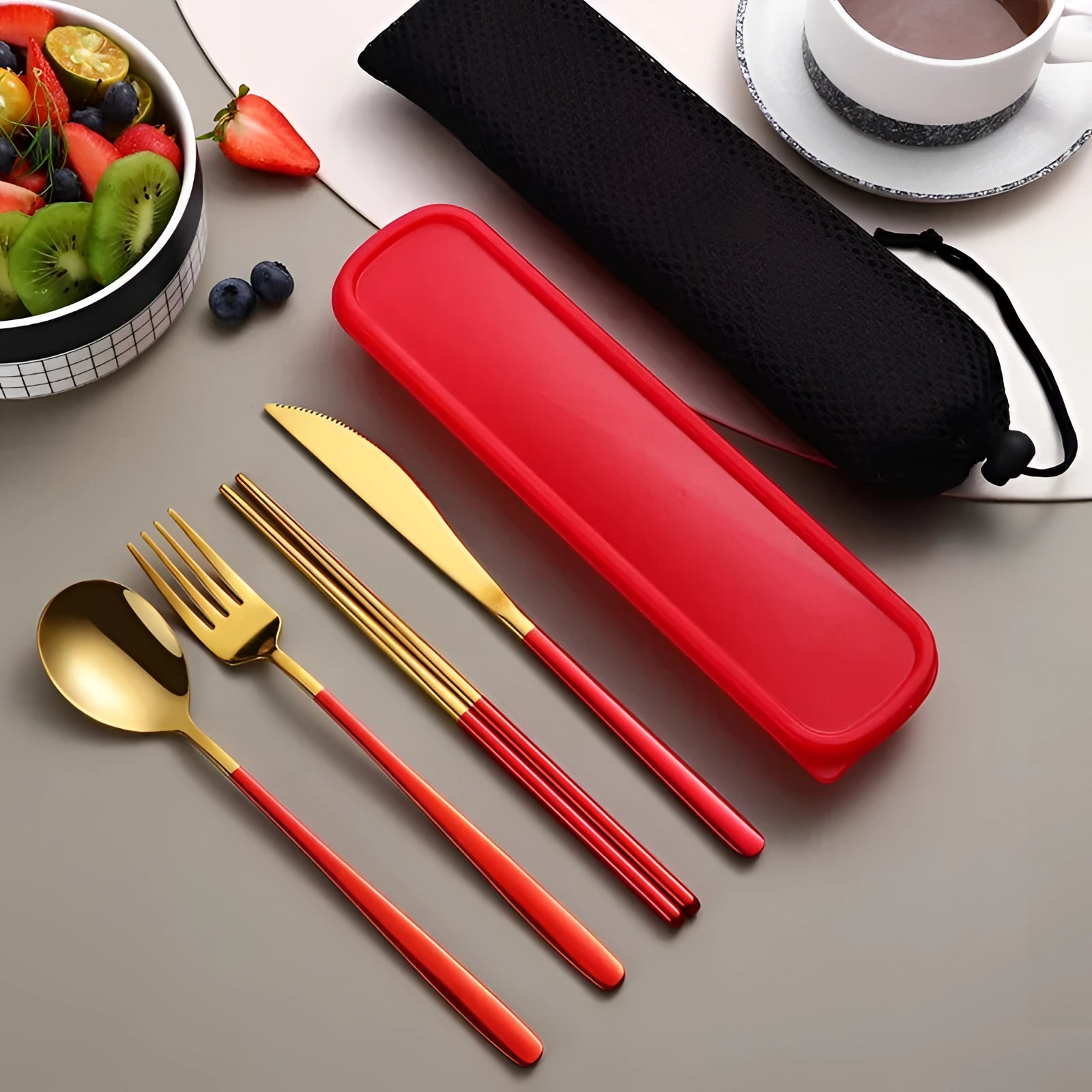 Portable eco-friendly stainless steel travel cutlery set in red-gold color displayed in a rectangular case on a table.