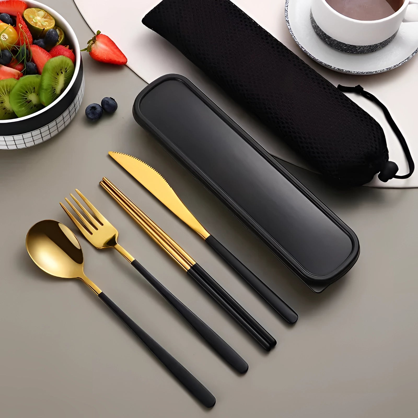 Portable eco-friendly black-gold stainless steel travel cutlery set with a stylish case, featuring a fork, spoon, knife, and chopsticks, ideal for sustainable dining on-the-go.