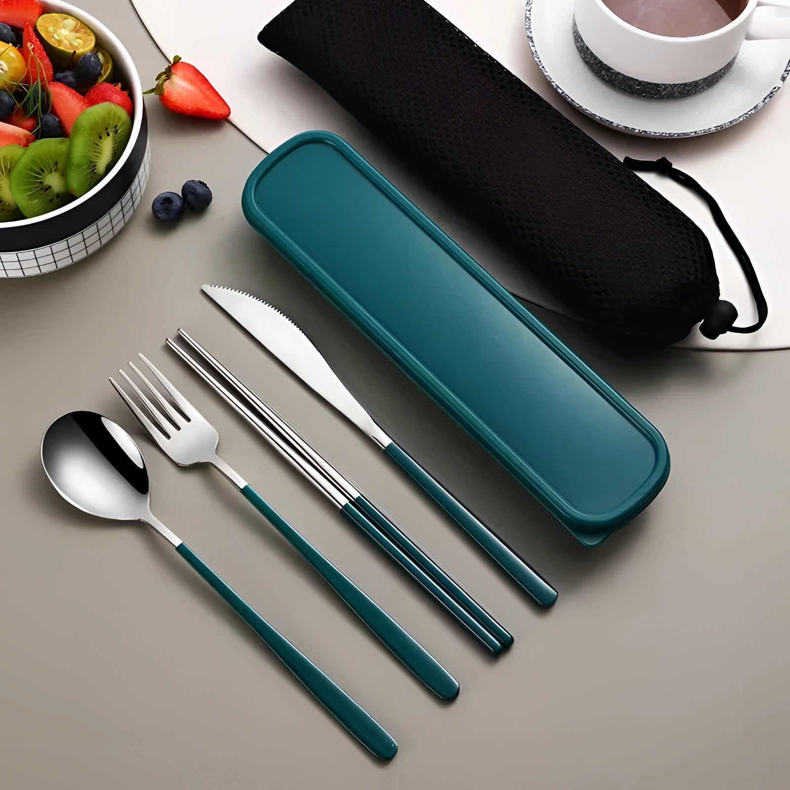 Portable eco-friendly stainless steel travel cutlery set in a green and silver color combination, featuring a fork, spoon, and knife, neatly arranged inside a rectangular case. A fabric napkin is included, complementing the functional and stylish design ideal for on-the-go dining.