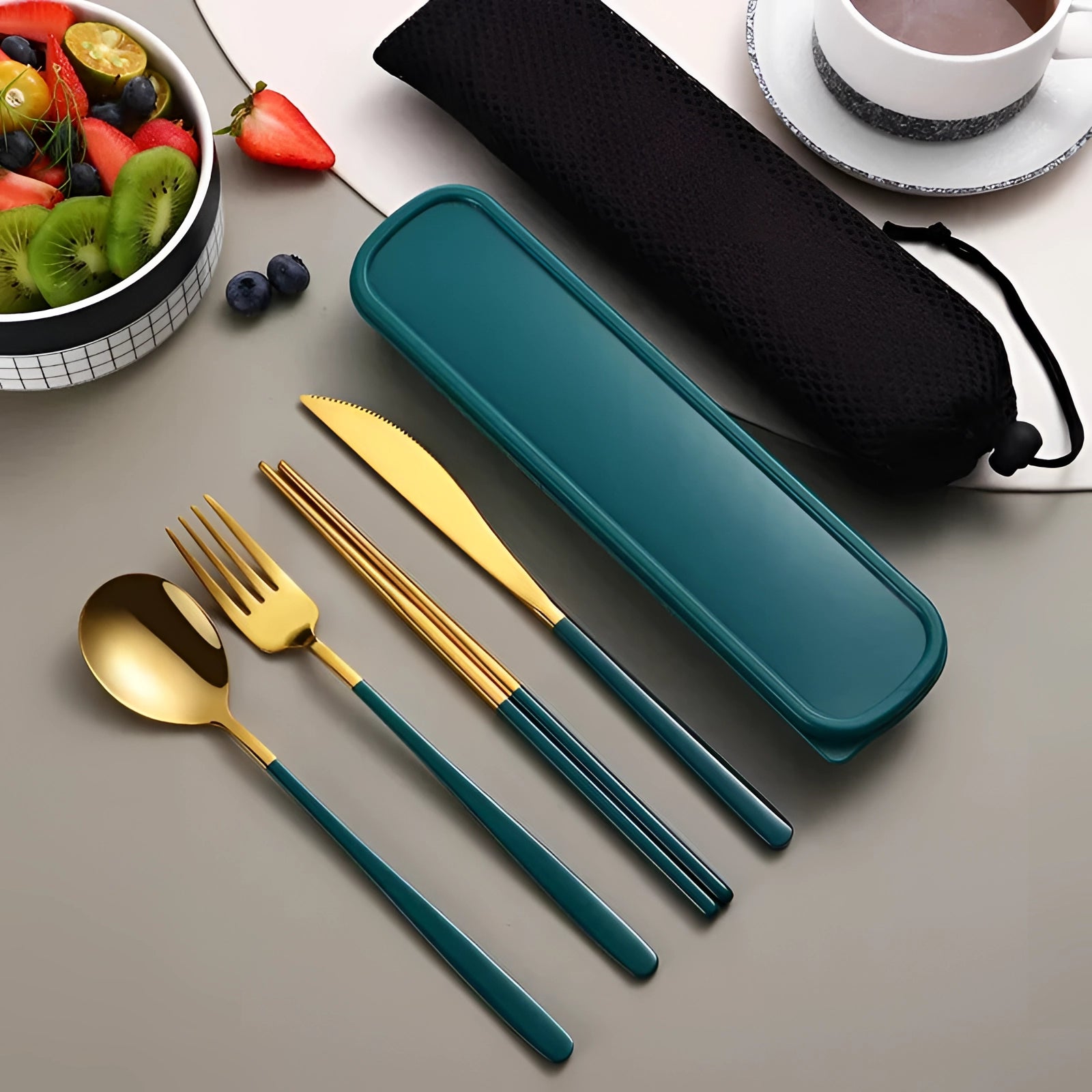 Portable eco-friendly stainless steel travel cutlery set in a green-gold finish, displayed on a table.