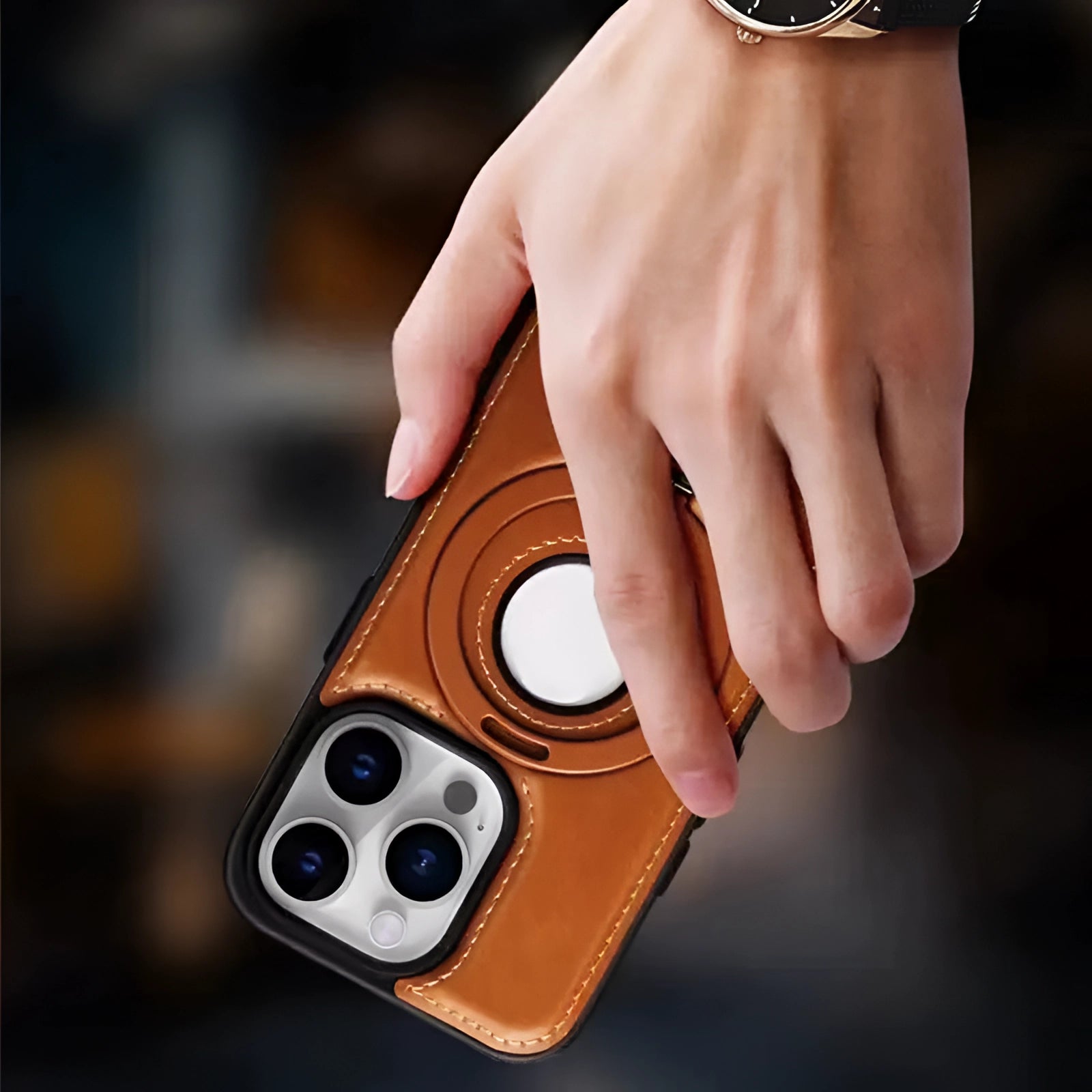 Premium Leather iPhone 13 Case with MagSafe and Camera Protection held in a hand, showcasing the sleek design and precise cutouts for easy access to device features.