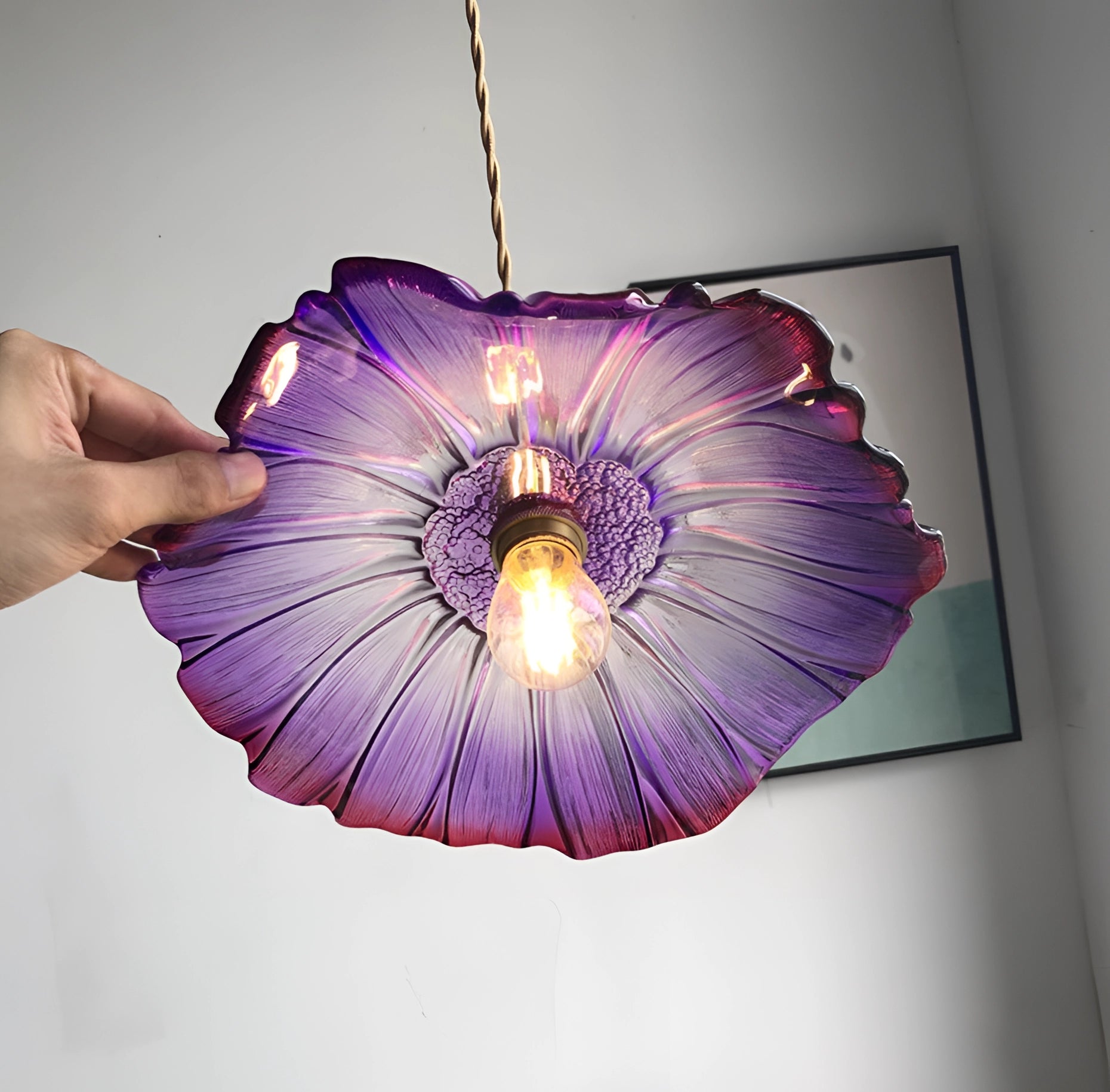 Purple flower handblown glass pendant light with artistic petal design, featuring shades of violet and an electric blue tint, showcasing symmetry and artisanal craftsmanship.