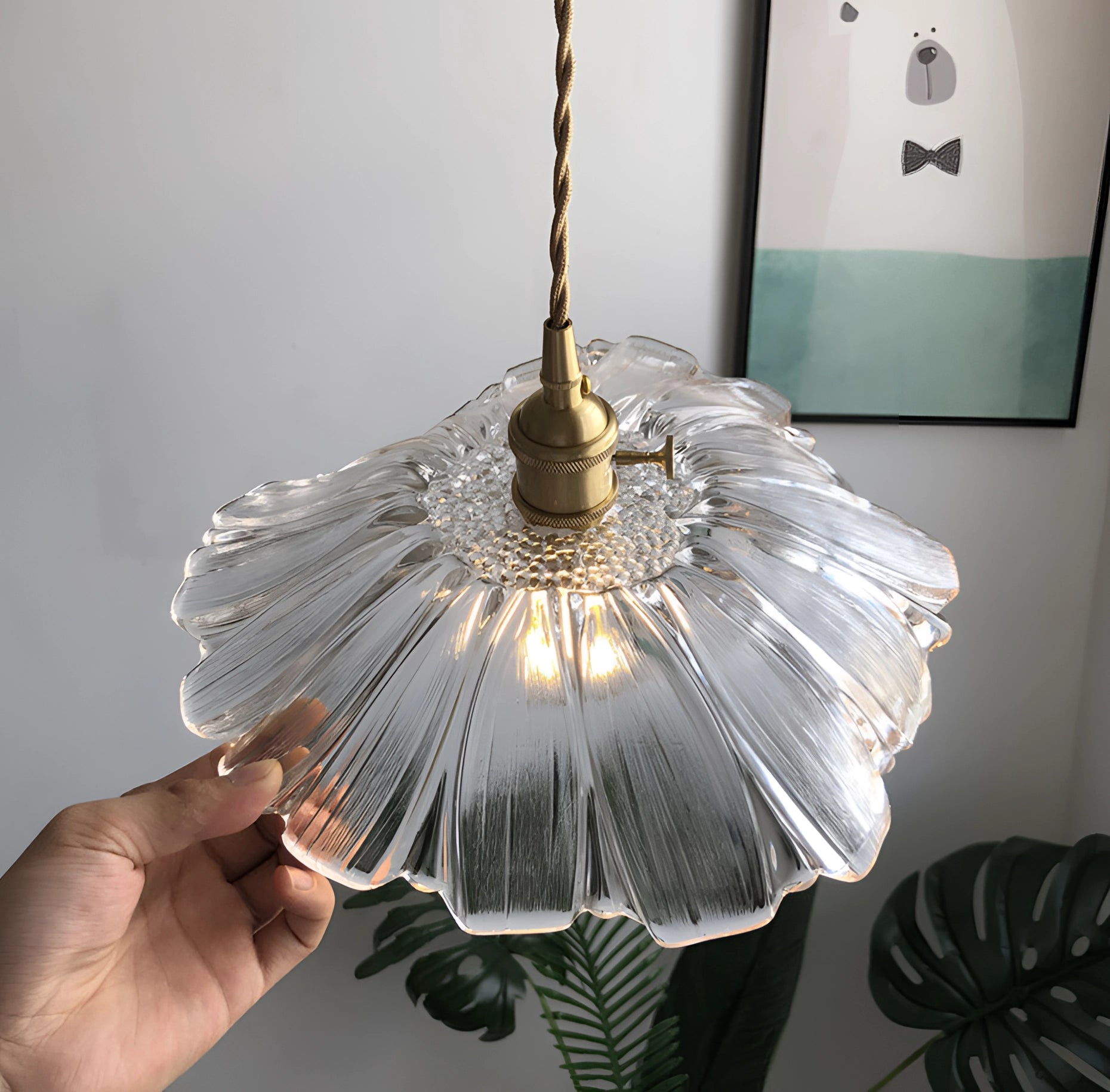 Purple flower-themed handblown glass pendant light featuring an artistic circular design with metal accents, elegantly suspended as a ceiling fixture.