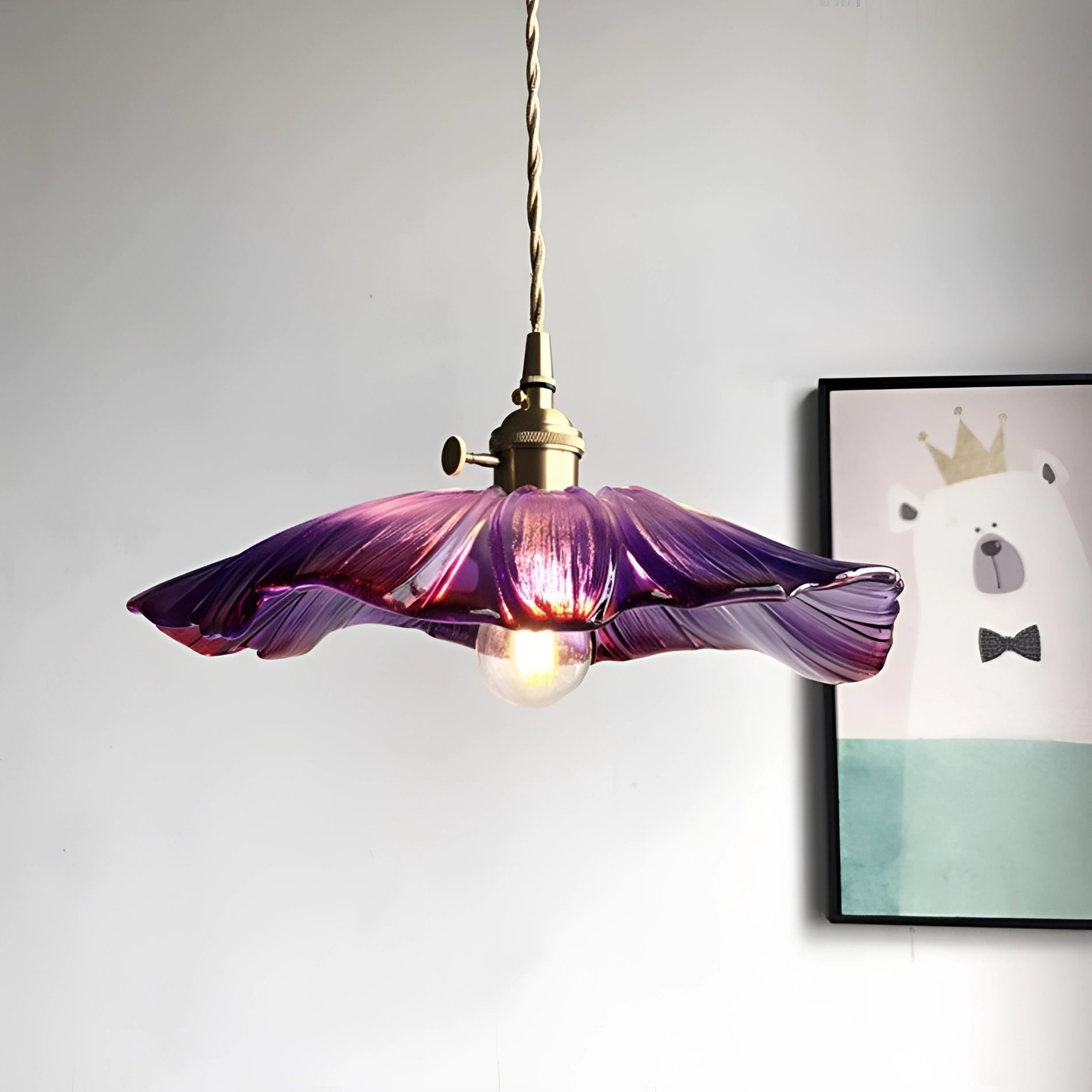 Purple handblown glass pendant light in the shape of a flower, featuring artistic design with vibrant violet and magenta shades, suitable for ceiling installation.