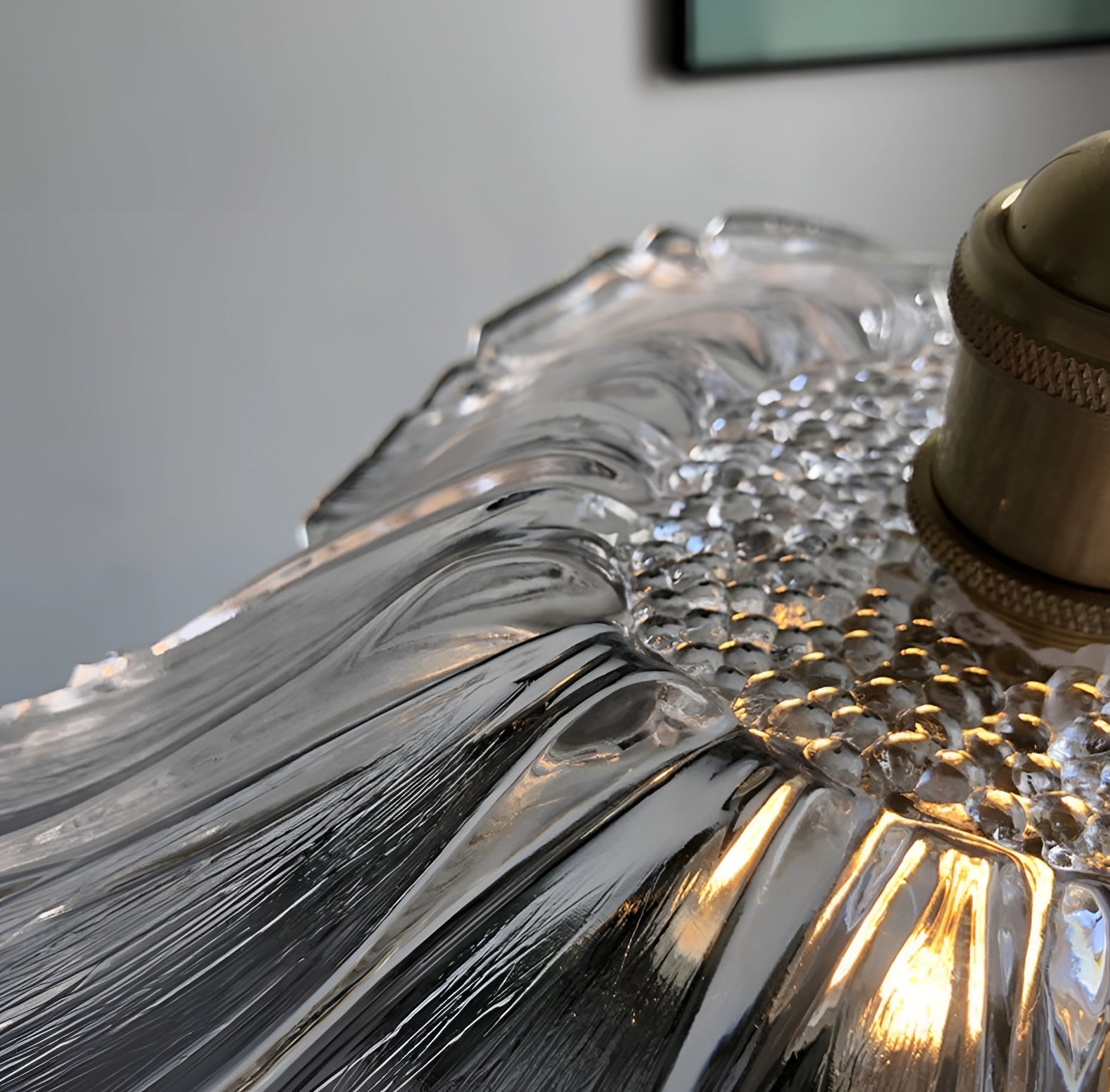 Purple flower handblown glass pendant light with artistic design, featuring a glass fixture and wood accents, suspended from a ceiling.