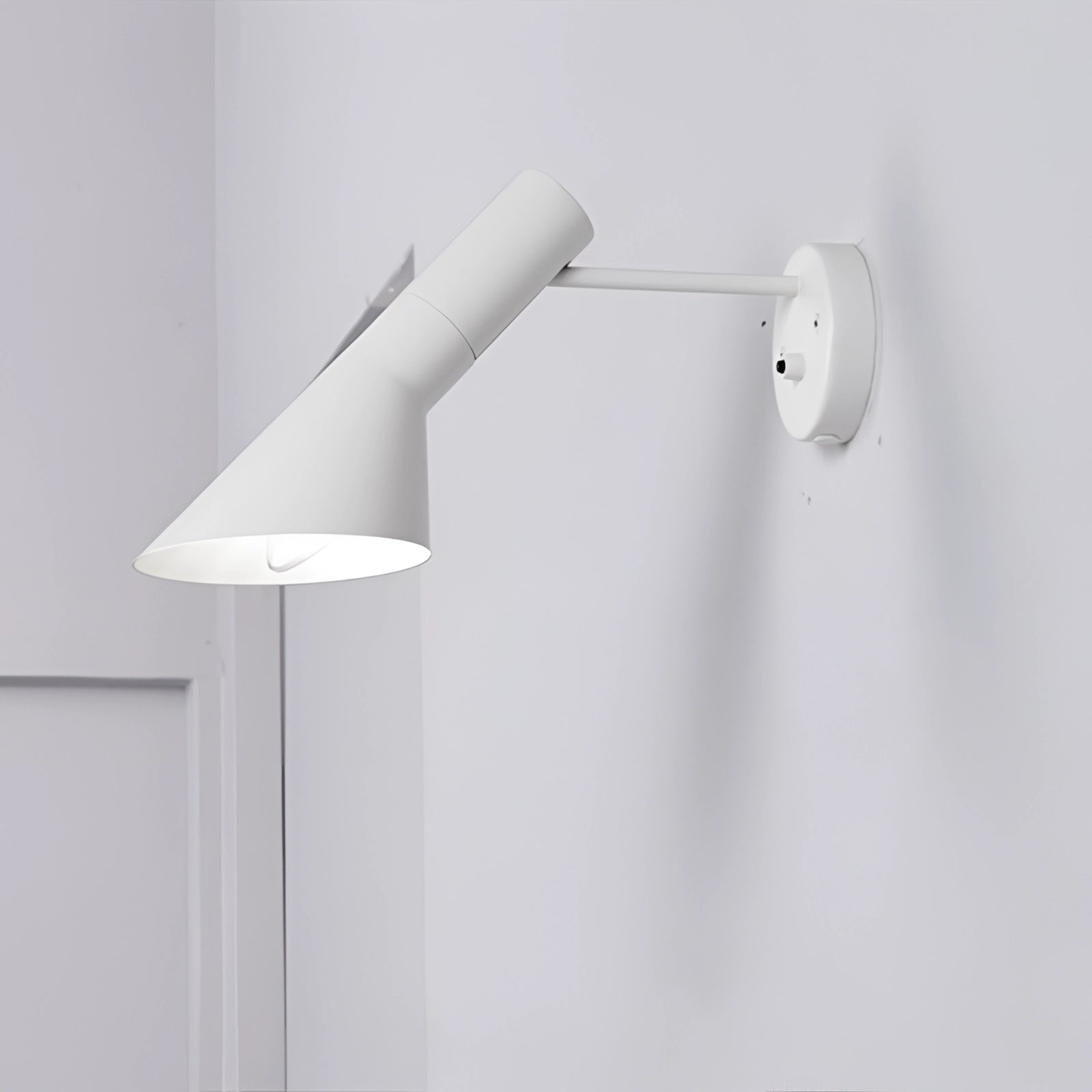 Modern rectangular silver mirror and wall light set in a bathroom setting, featuring a white color variant. The image showcases a sleek and contemporary design, with a wall-mounted light fixture above the mirror, emitting a soft fluorescent glow. The mirror has a silver frame, complementing the minimalist and elegant aesthetic of the space.