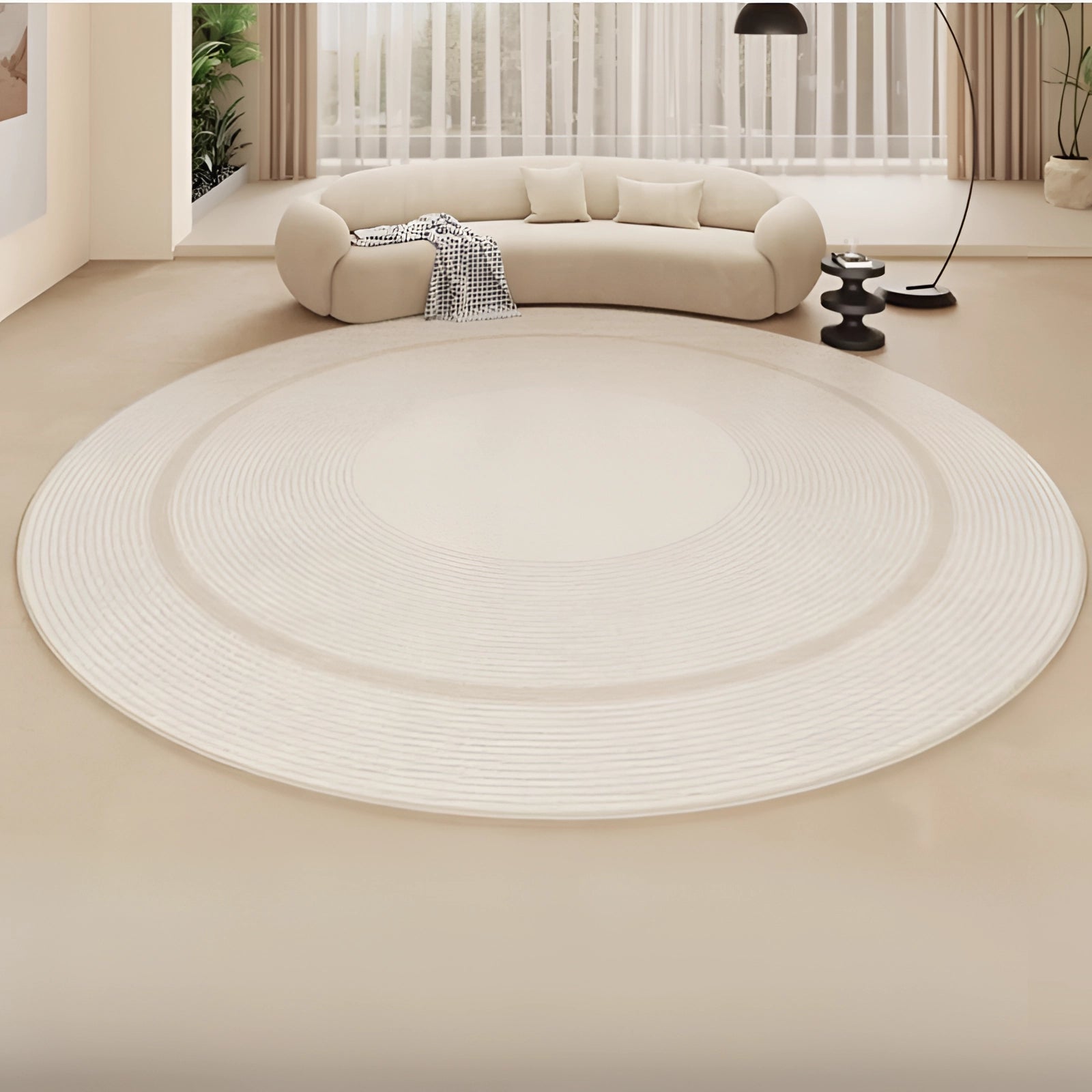 Round beige rug with a soft texture, placed in a contemporary minimalist interior setting, surrounded by furniture including a couch and a table, enhancing the overall comfort and design aesthetic of the room.