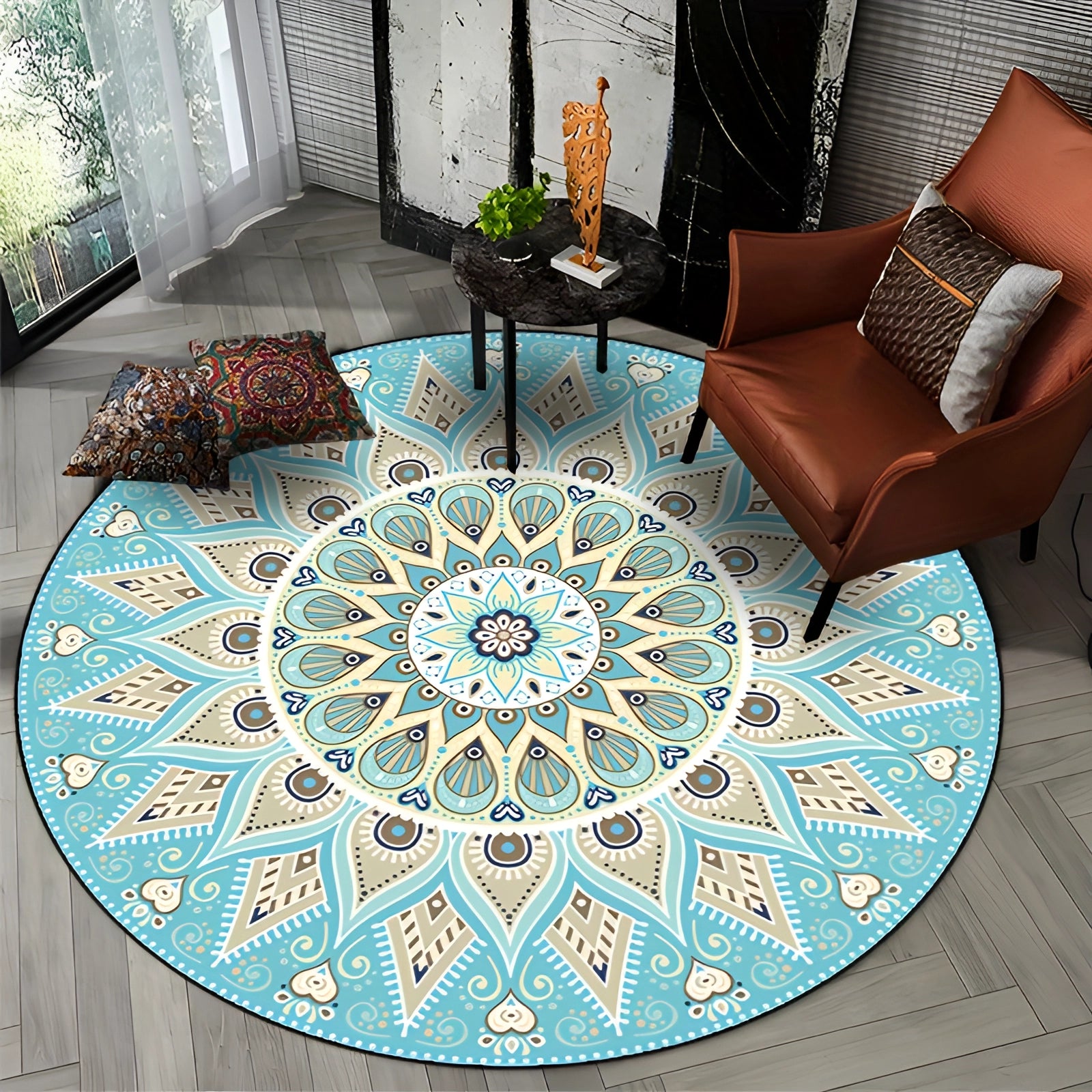 
A large round blue mandala rug with intricate bohemian designs, predominantly turquoise, placed on a wooden floor in a stylish interior setting.