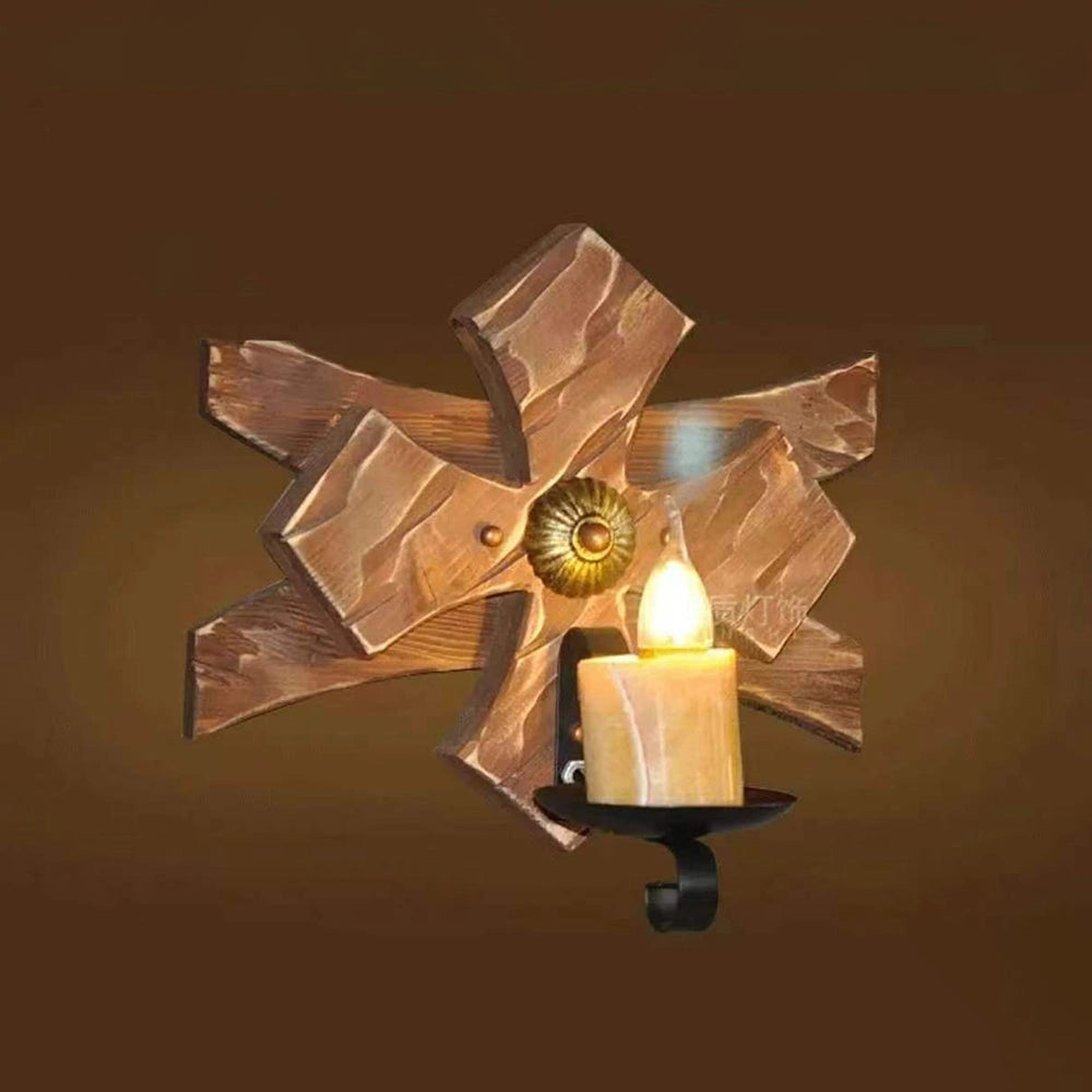 Rustic wooden star wall sconce featuring an industrial glass lantern with amber tints, combining wood and metal elements in a creative and artistic design.