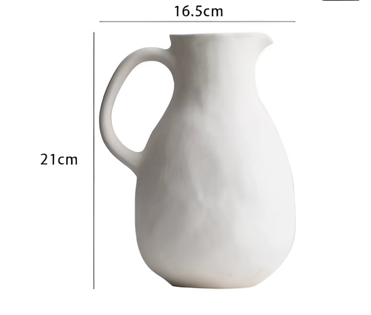 Scandinavian minimalist white ceramic flower jug vase placed on a wooden table, showcasing its sleek porcelain design and artistic craftsmanship.