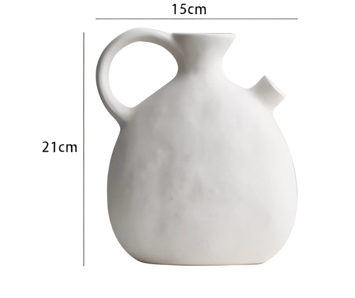 Minimalist white ceramic flower jug in Scandinavian design with a smooth, round shape, suitable as a decorative vase for home decor.