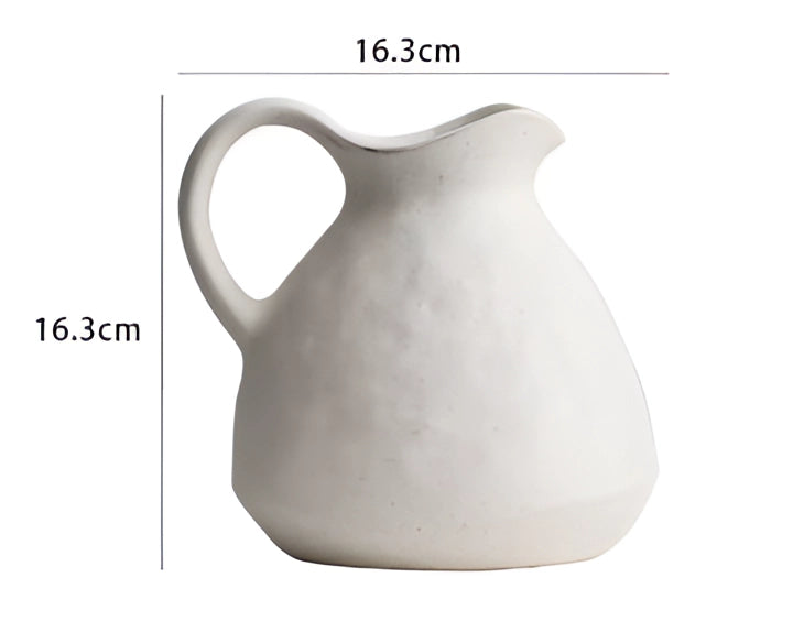 Minimalist white Scandinavian ceramic flower jug with a sleek design, suitable for use as a decorative vase.