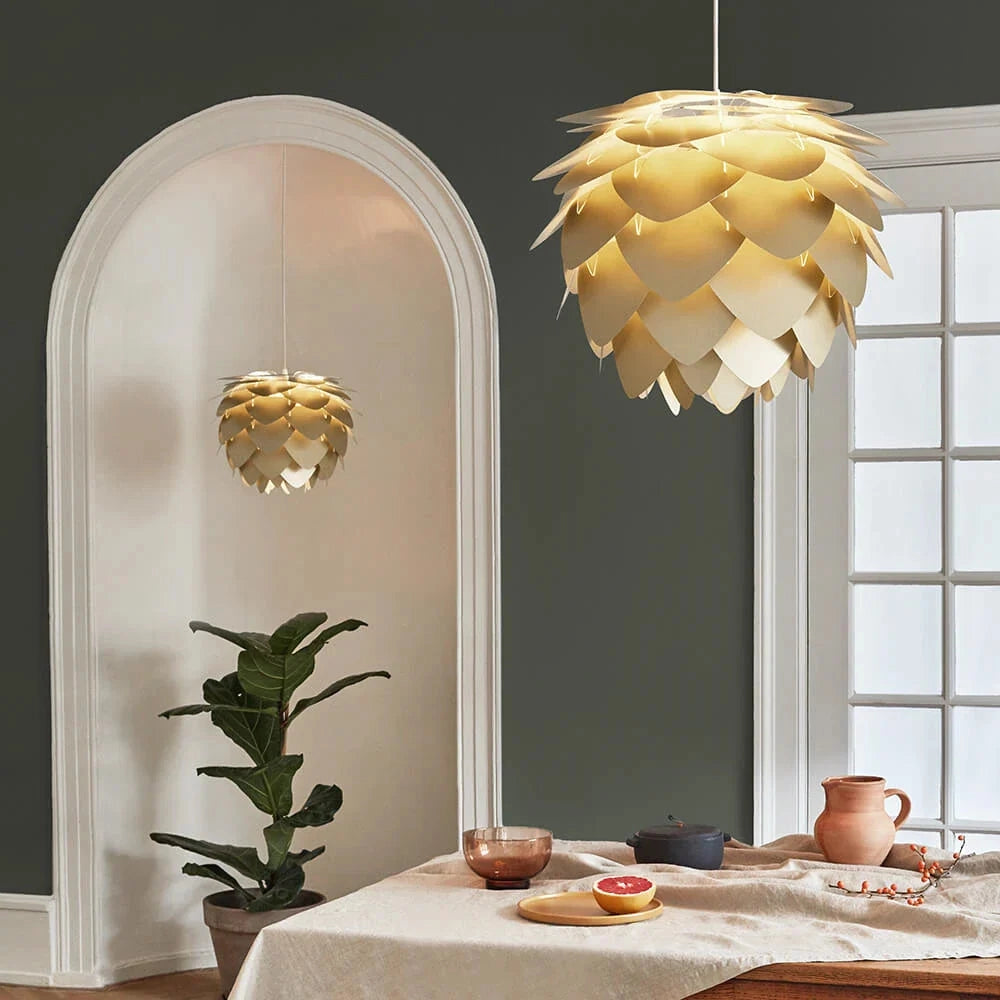 Scandinavian Pinecone Pendant Light with a modern organic design, featuring a wooden shade, hanging in a stylish interior setting with a window in the background.