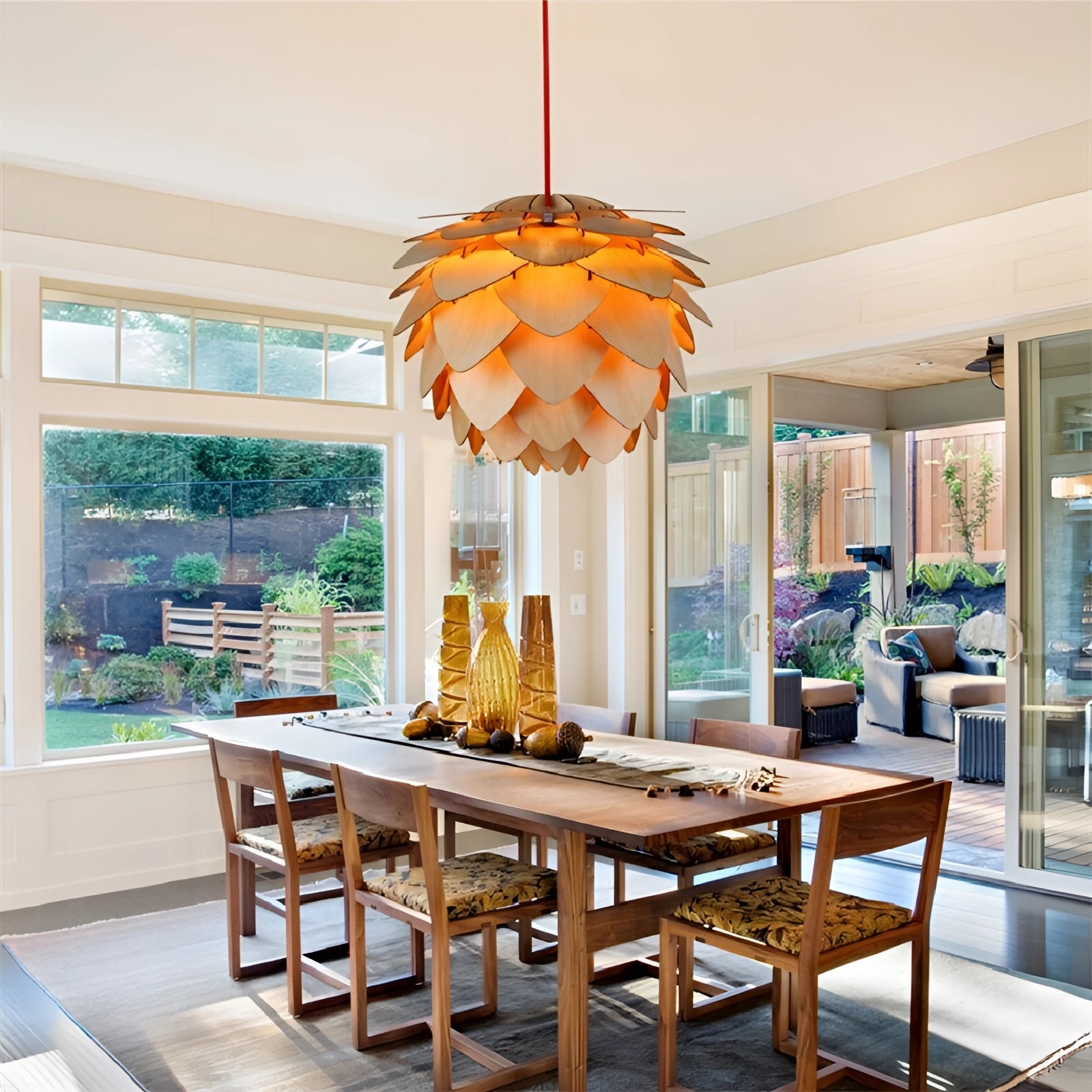 A Scandinavian pinecone pendant light hanging from the ceiling, showcasing a modern organic design, with wooden elements visible, illuminating a well-furnished interior space.