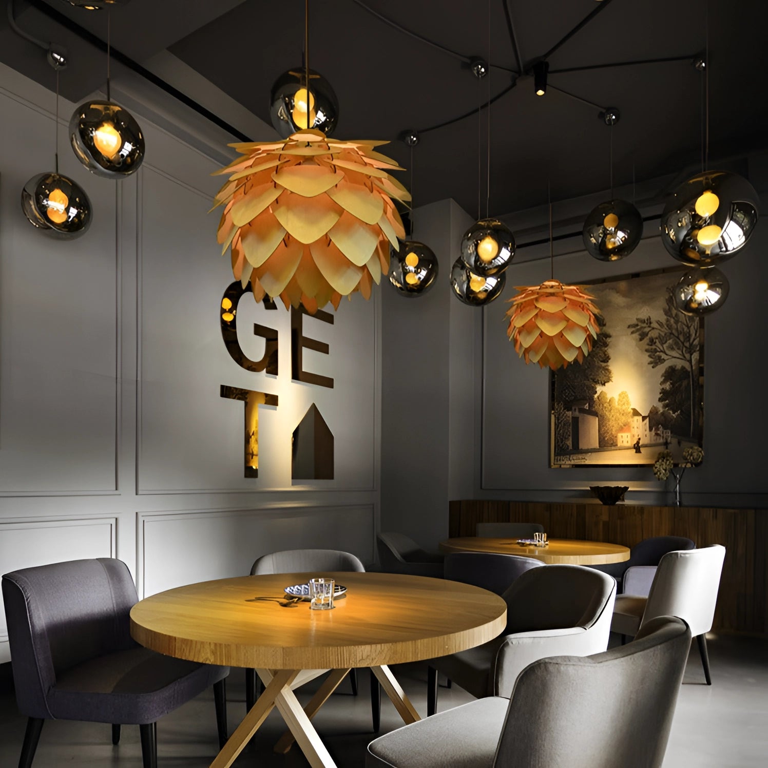 Modern Scandinavian pinecone pendant light hanging from the ceiling, casting a warm yellow glow over a stylish interior with wooden flooring, a table, and chairs.