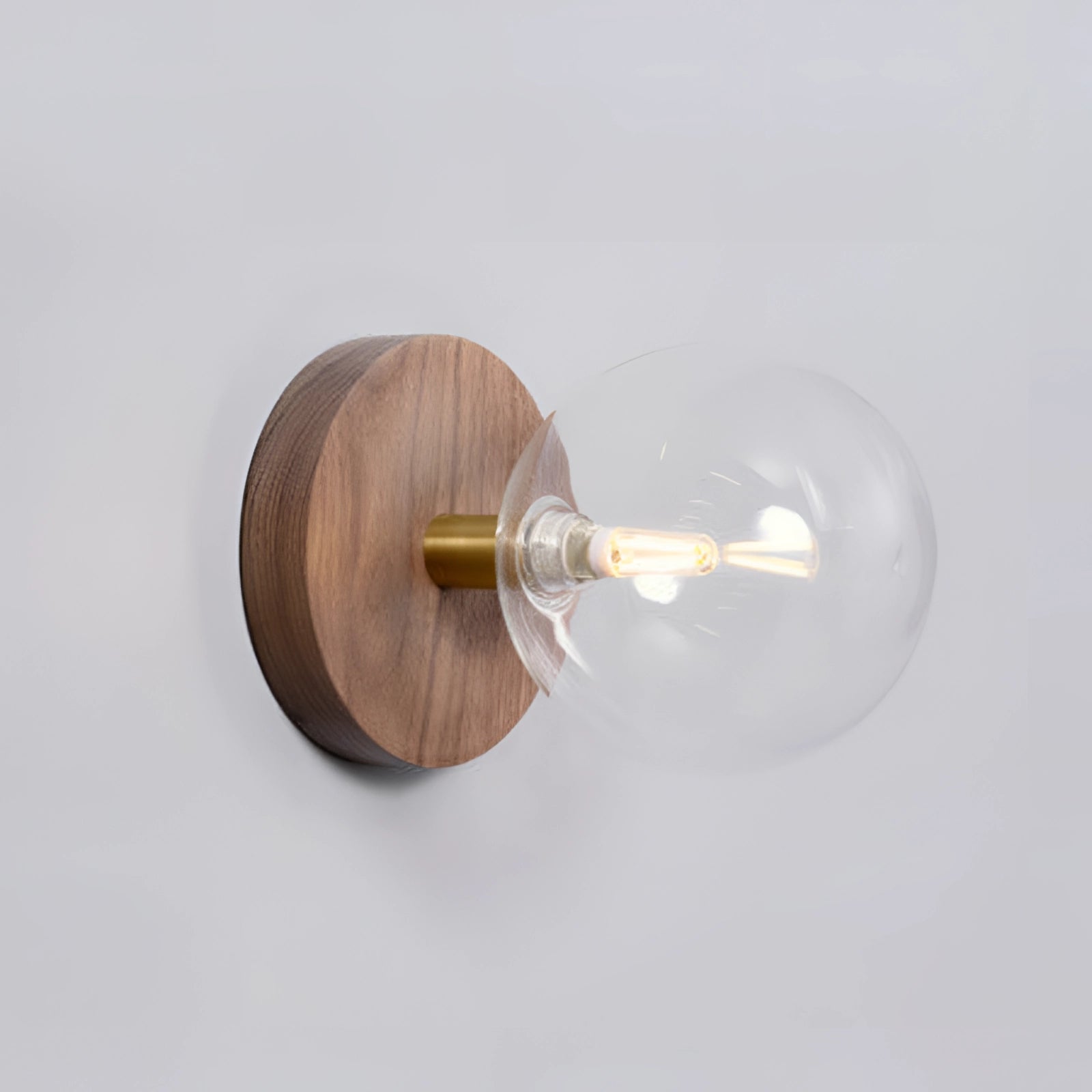 Minimalist Scandinavian wooden wall sconce with a clear glass cover, cylindrical shape, and eco-friendly design featuring natural wood and metal accents.