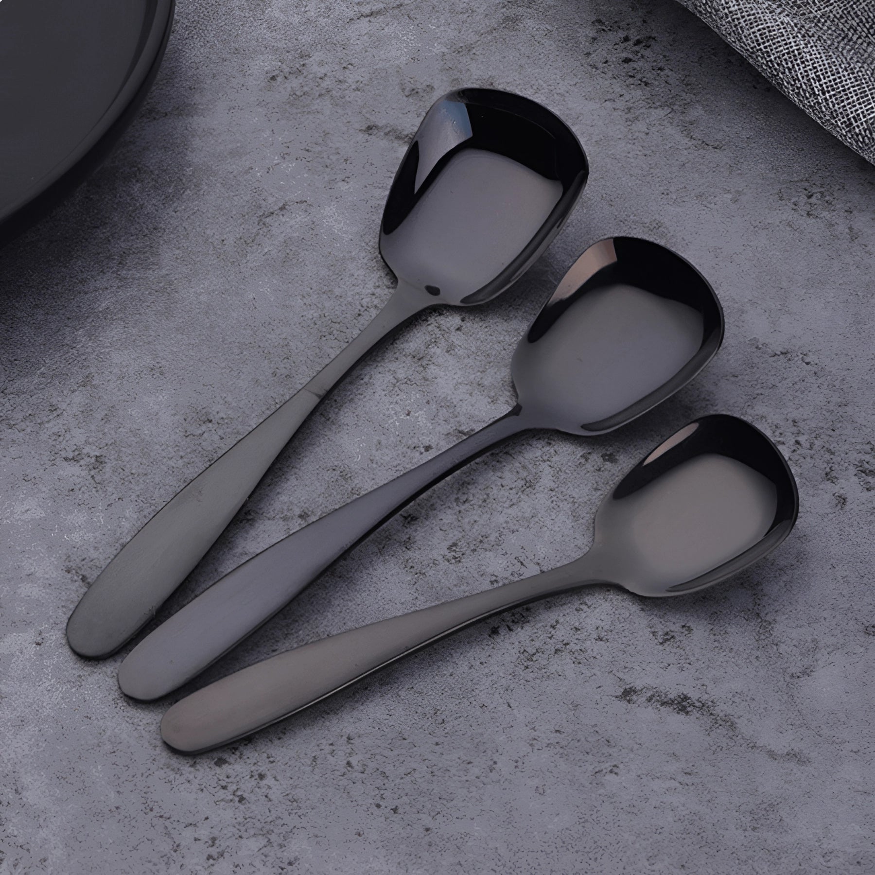 Sleek black stainless steel spoon set with a matte finish, showcasing a modern and elegant design suitable for contemporary dining settings.