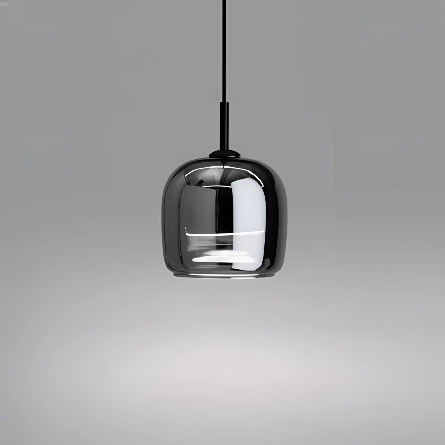 Smoked glass pendant light with a minimalist industrial design, hanging from the ceiling, suitable for kitchens.