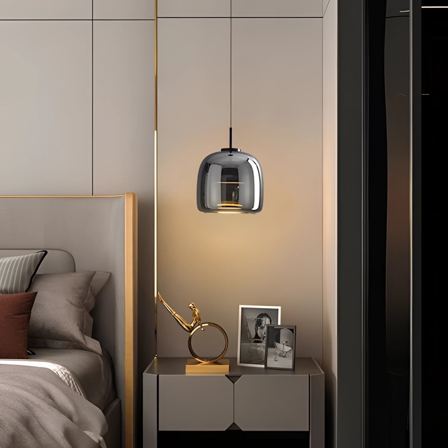 Minimalist industrial smoked glass pendant light hanging in a modern kitchen interior with wood accents and grey furnishings.