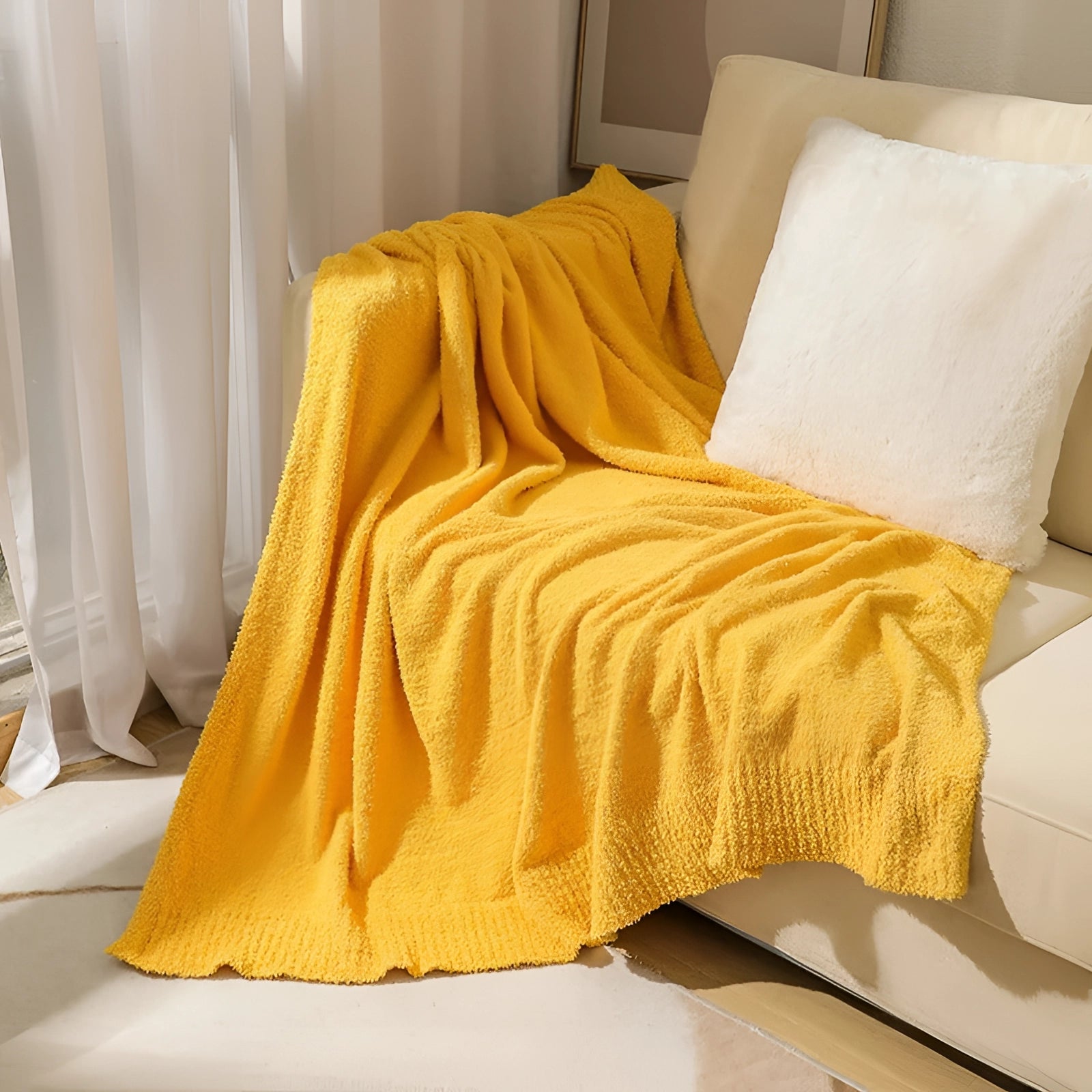 Luxurious yellow velvet blanket draped elegantly over a wooden floor, enhancing the cozy and inviting interior design of the room.