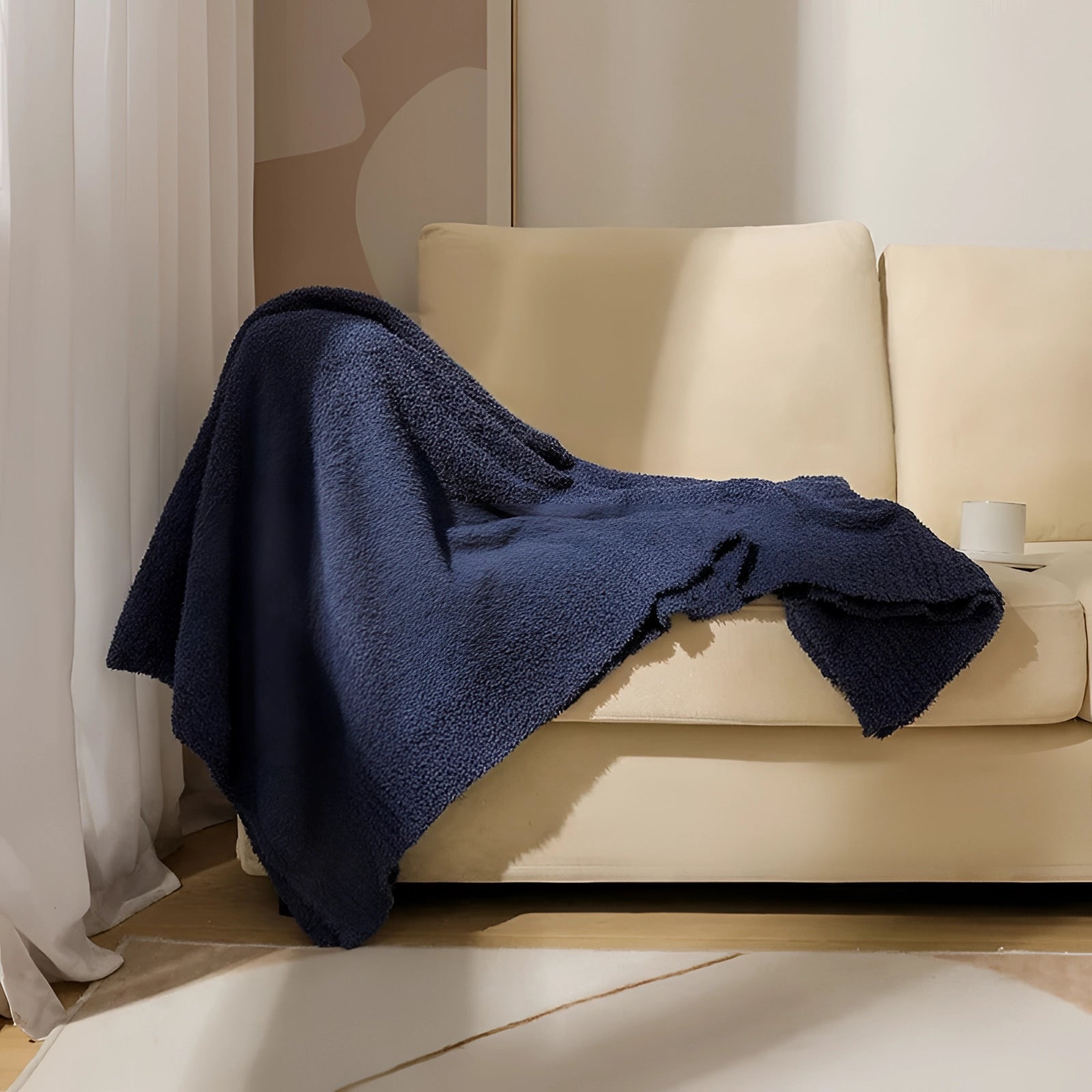 
A luxurious blue velvet blanket measuring 150 x 200 cm draped elegantly over a hardwood floor, showcasing its soft and plush texture, perfect for adding comfort and style to any interior space.