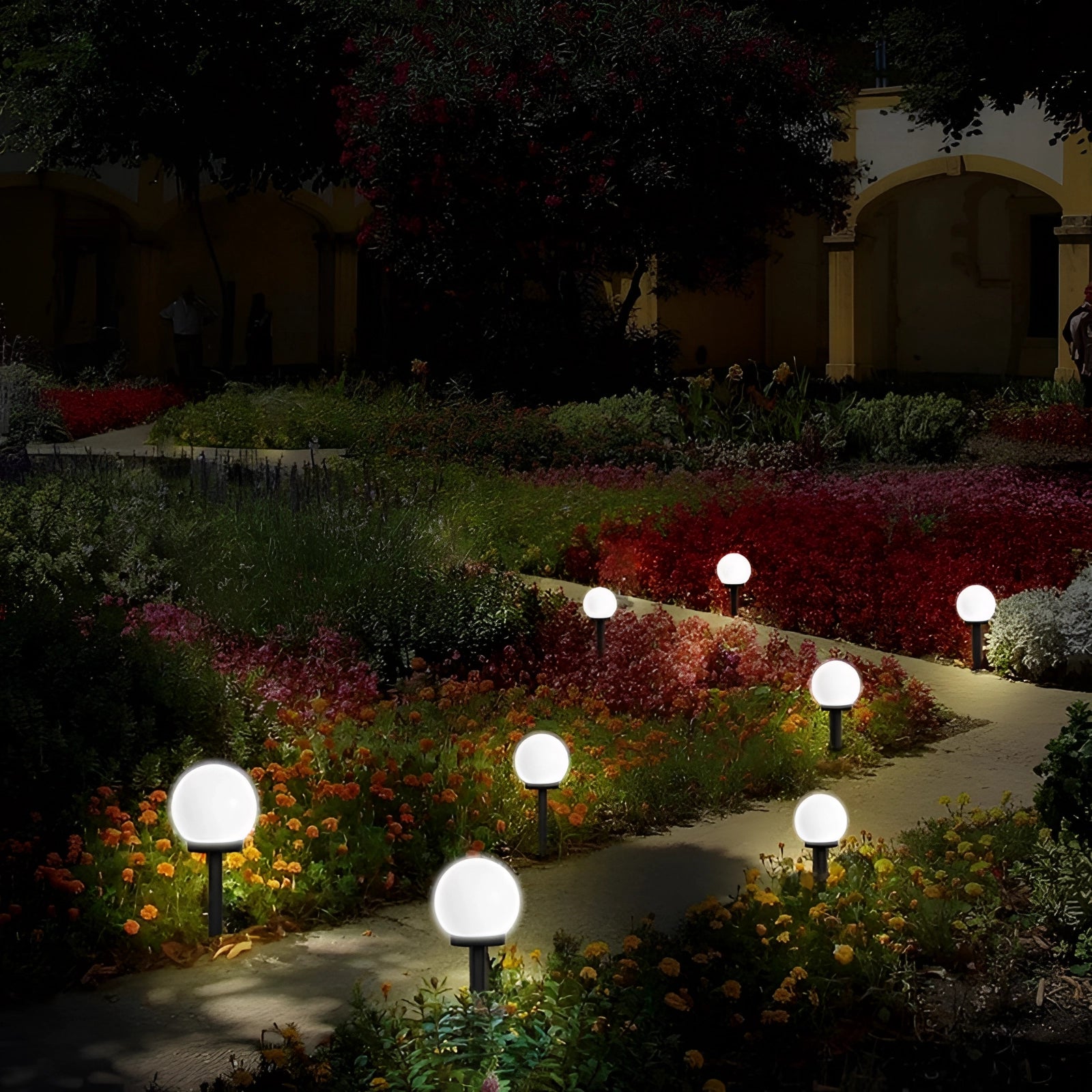 Solar LED garden sphere lights illuminating a garden setting, surrounded by lush green plants and foliage, creating an eco-friendly and enchanting outdoor ambiance.