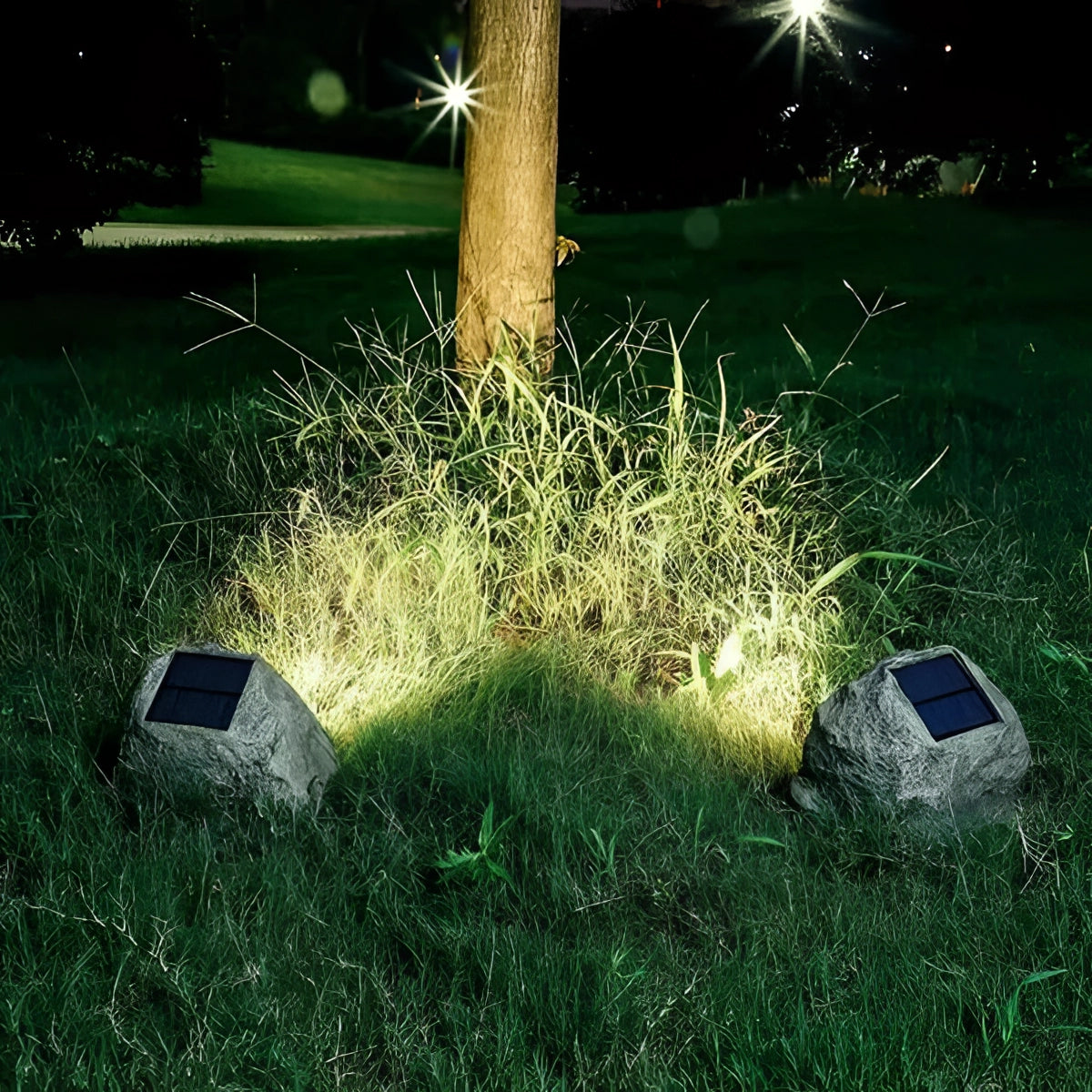 Solar-powered LED rock lights illuminating a garden with grass, plants, and trees