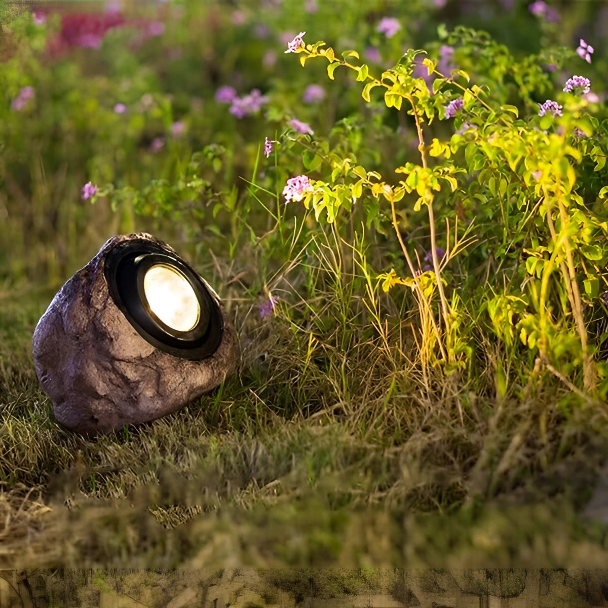 Solar-powered LED rock lights placed among garden plants and flowers, illuminating the landscape with a natural and decorative touch.