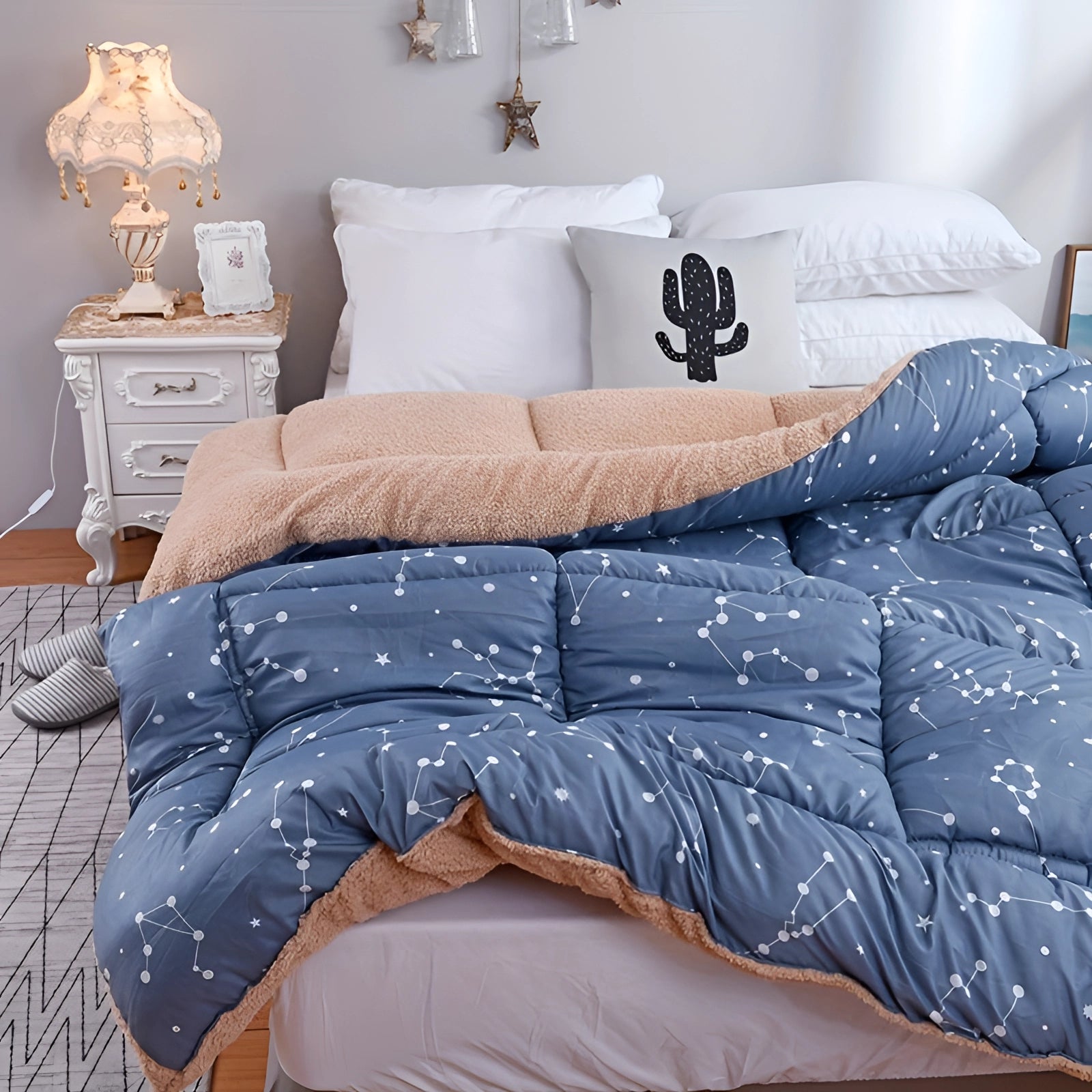 Weighted blanket in a blue star pattern draped over a grey couch with white and azure accents, designed to provide anxiety relief and improve sleep quality.