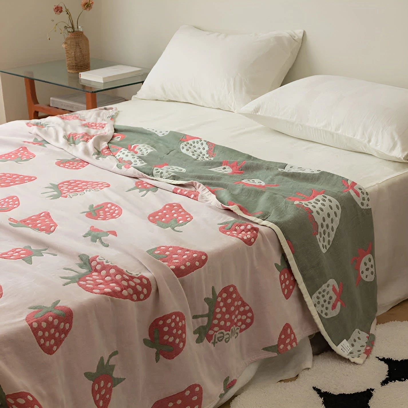 Off white blanket with a cute strawberry pattern draped over a bed in a well-decorated bedroom, measuring 200x230cm.