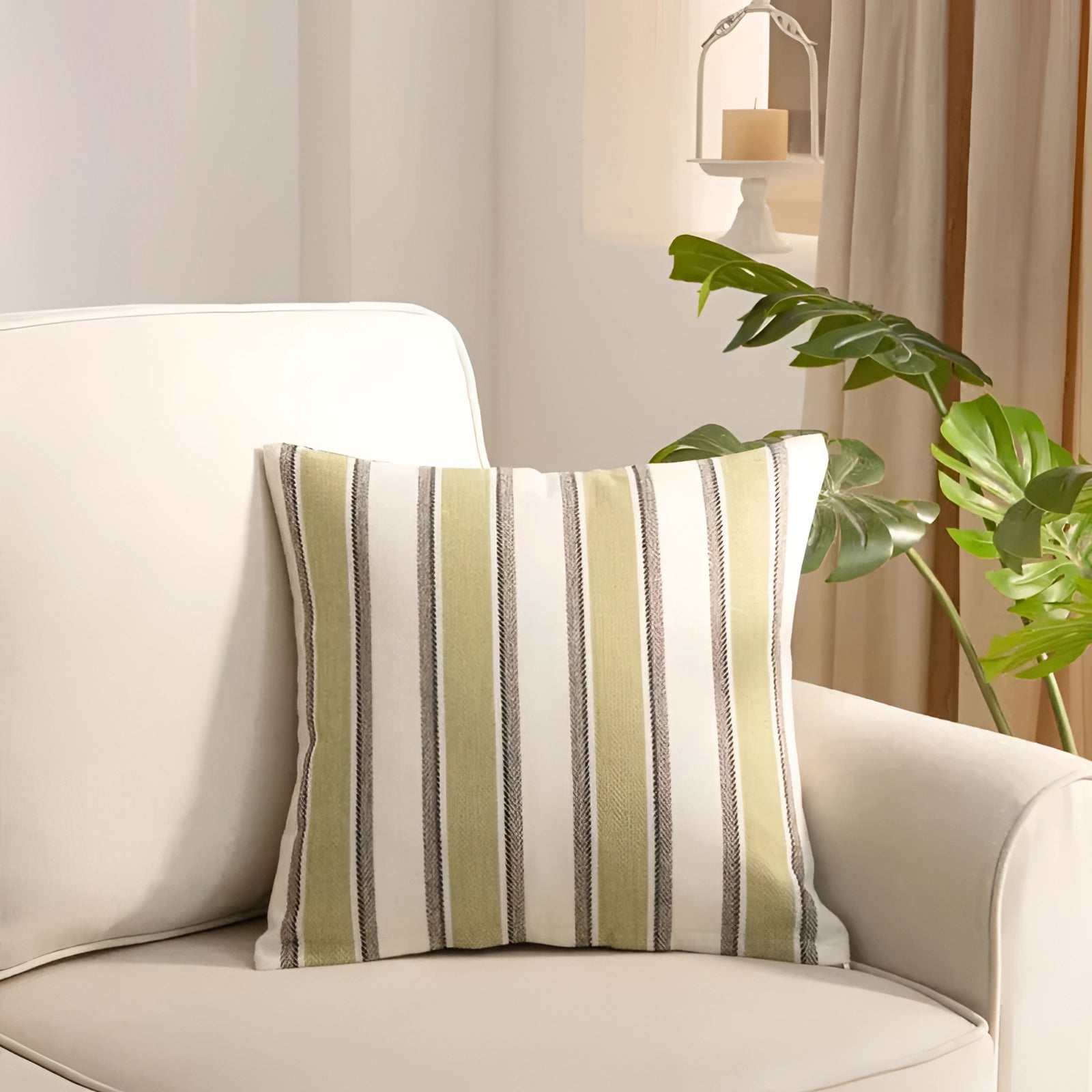 Striped accent pillows on a modern living room couch, surrounded by neutral decor elements including a wooden coffee table, potted plant, and soft lighting, creating a comfortable and stylish interior design.