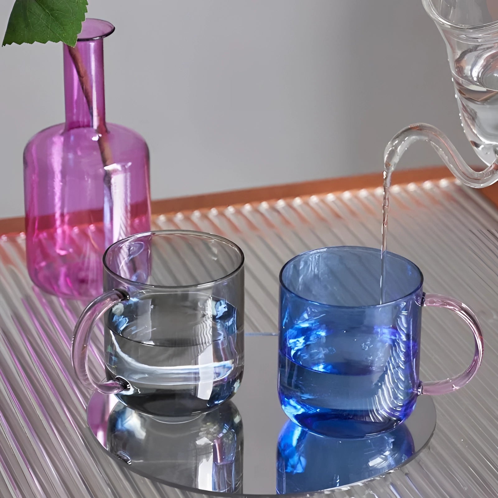 A set of stylish lightweight pink glass coffee and tea mugs with a unique design, perfect for enhancing your drinkware collection.