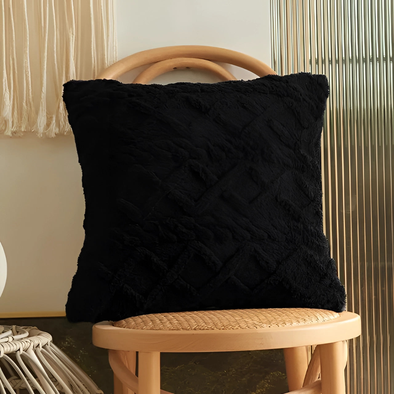 Set of six textured velvet throw pillows in black, featuring geometric multi-color patterns, placed on a wood surface, showcasing comfort and modern interior design.