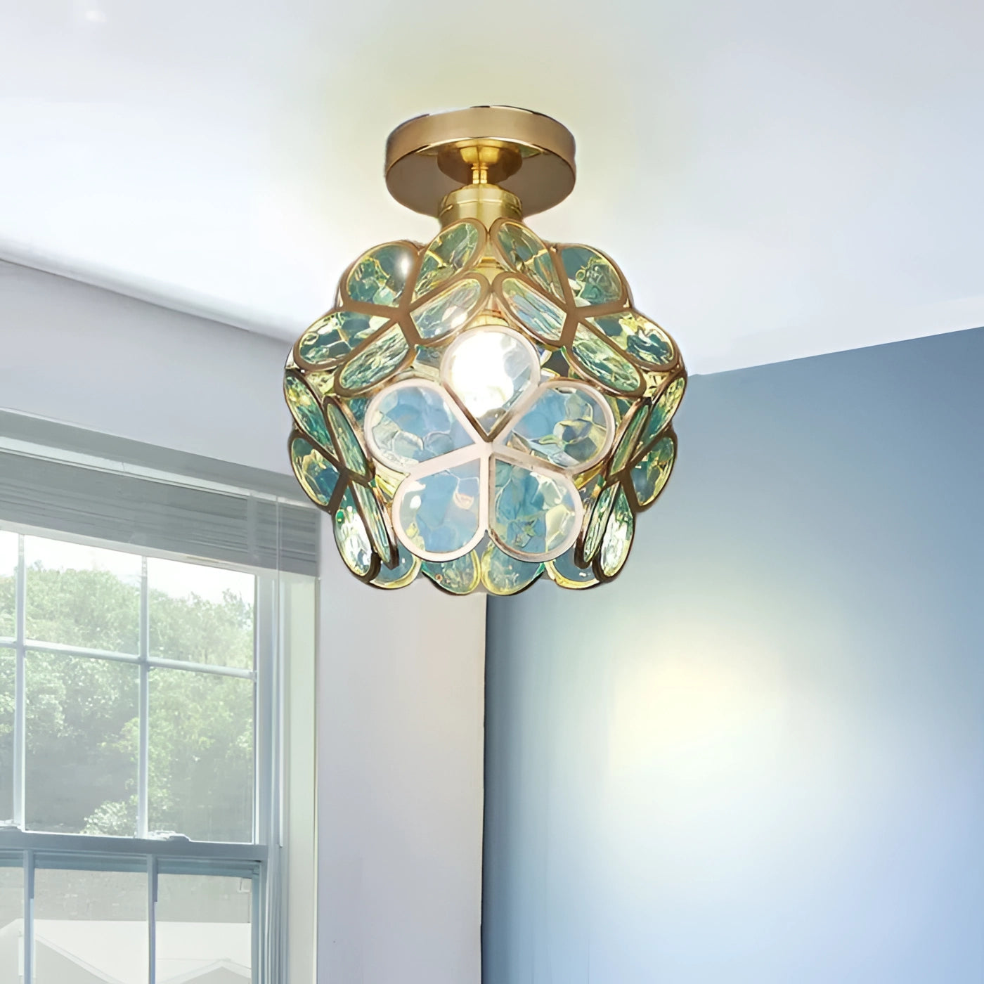 Tiffany style stained glass ceiling light with Art Nouveau design in shades of green, featuring symmetrical patterns and ornamental details.