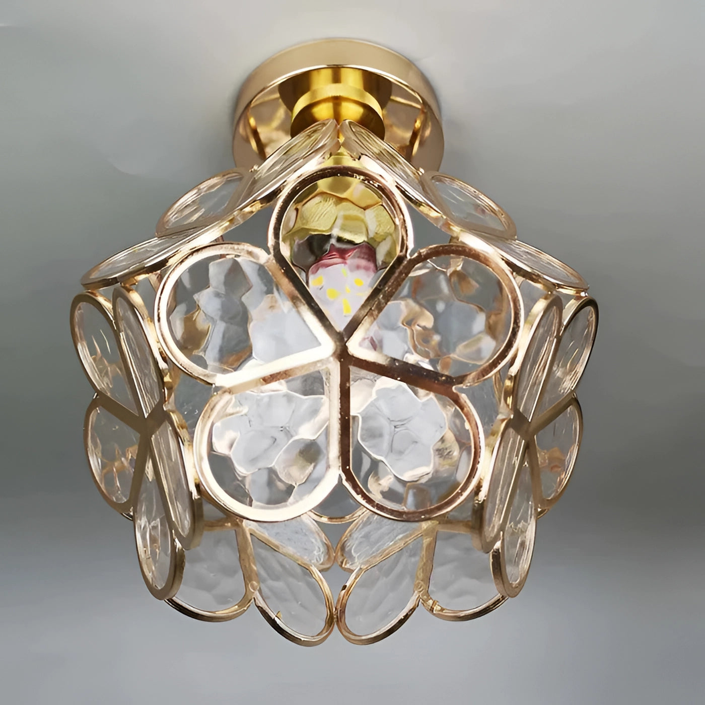 Tiffany style stained glass ceiling light with an Art Nouveau design, featuring a clear glass shade and amber accents, flush mounted to a silver fixture.