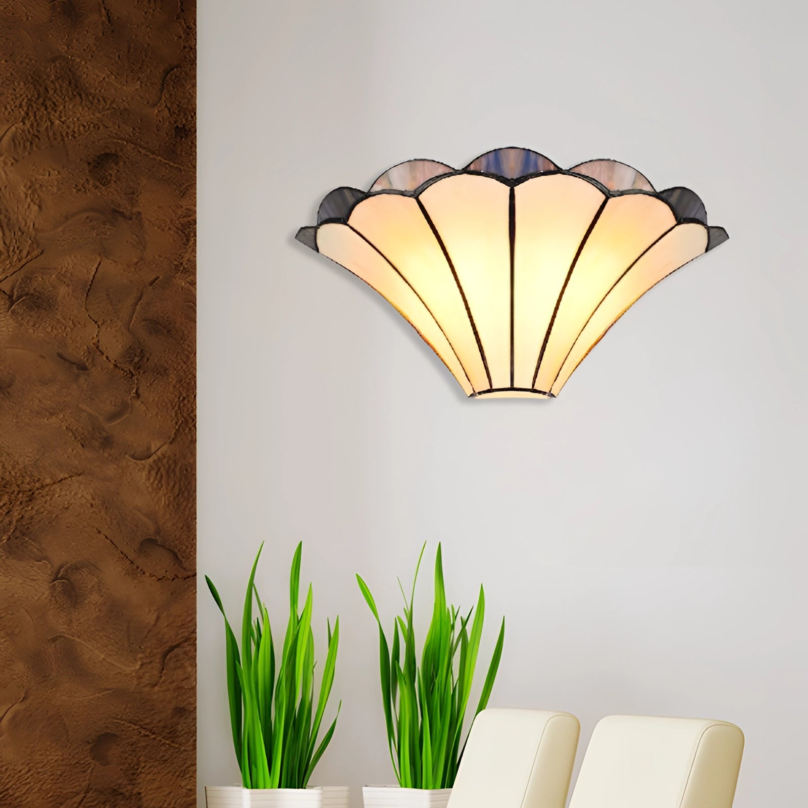 Tiffany-style stained glass shell wall sconce with an Art Deco design, featuring multicolored glass panels shaped like overlapping leaves, mounted on a wooden base.