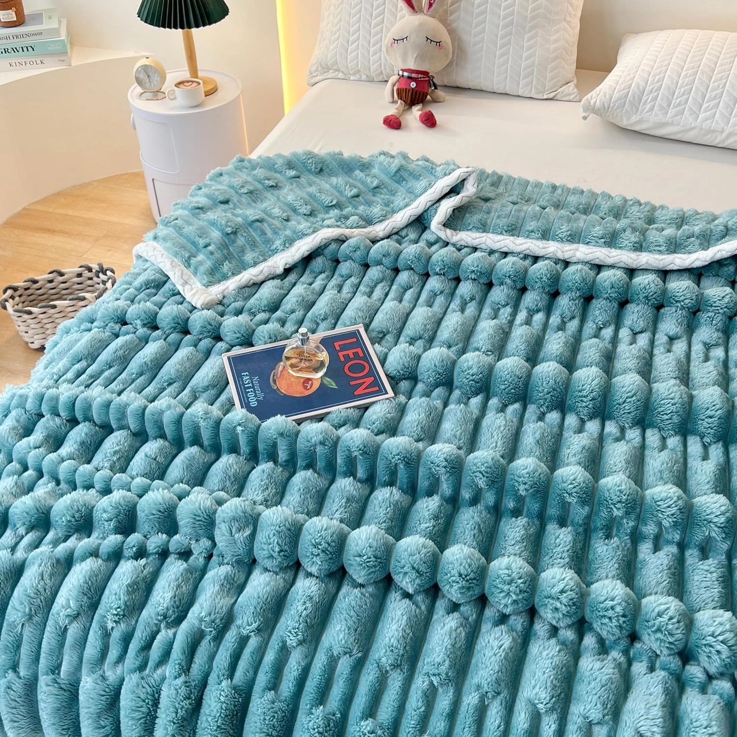 Luxurious turquoise chunky knit blanket with a braided design, featured in matcha green, draped over a wooden surface, measuring 200cm by 230cm.