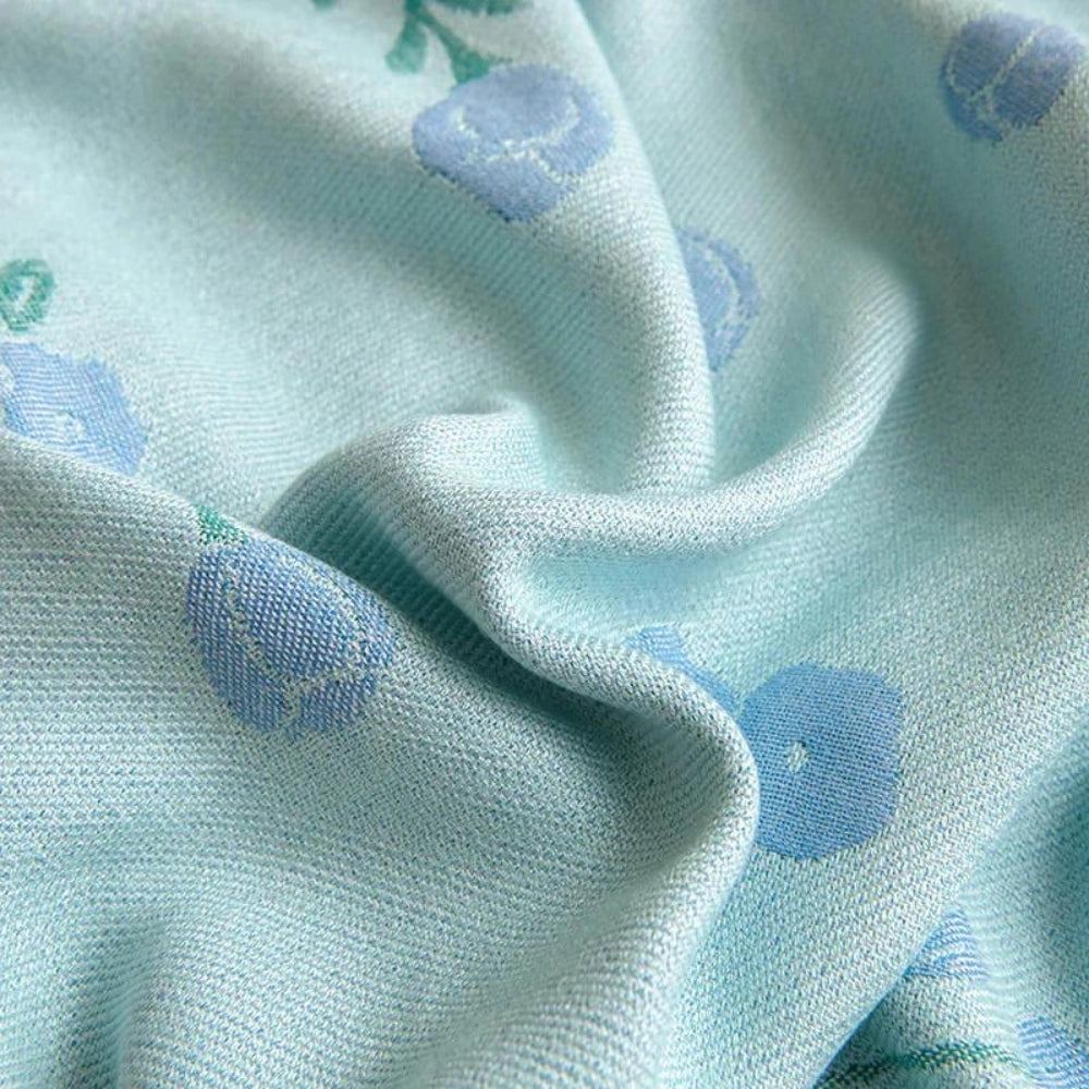 Turquoise floral designer bamboo cooling blanket in king size, featuring an intricate pattern with shades of azure and aqua, showcased in a close-up view highlighting the textile's detail and cooling properties.