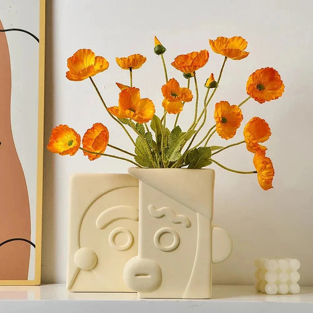 WiFi Signal Soap Bar in the shape of a flower with orange petals, displayed near a window with houseplants and decorative flower arrangements.