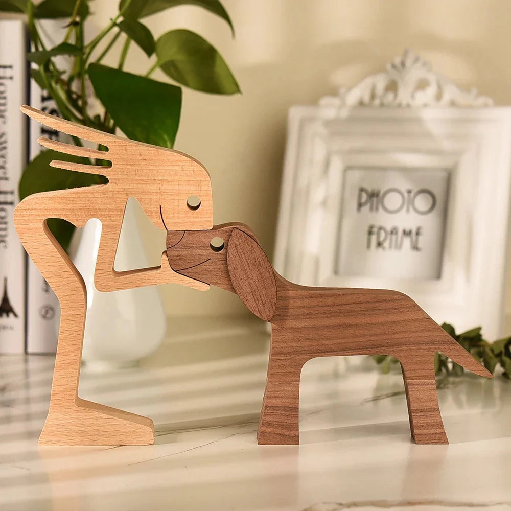 Wooden dog sculpture adorned with a striped scarf, featuring intricate carving details, situated on a wooden chair in a festive setting.