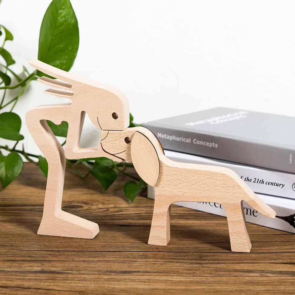 
A wooden dog sculpture featuring a striped scarf, designed as a festive holiday figurine, placed on a table setting.